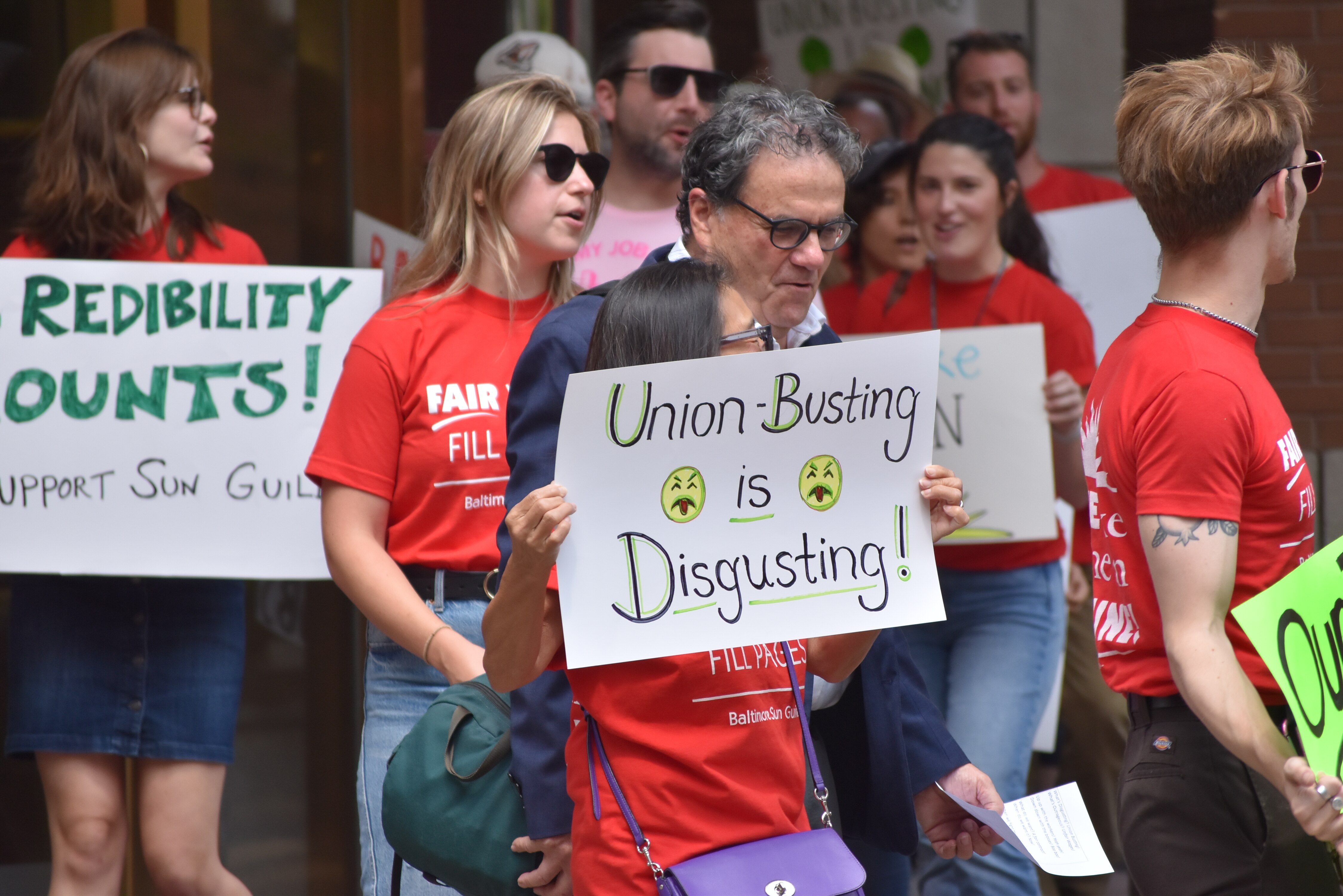 Unionized Baltimore Sun journalists and supporters rally outside the newspaper's downtown office building.