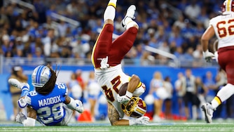 Washington Commanders running back Craig Reynolds (24) is flipped by Detroit Lions cornerback Avonte Maddox (29) during a preseason NFL football game, Saturday, Aug. 22, 2026, in Detroit. (AP Photo/Rey Del Rio)