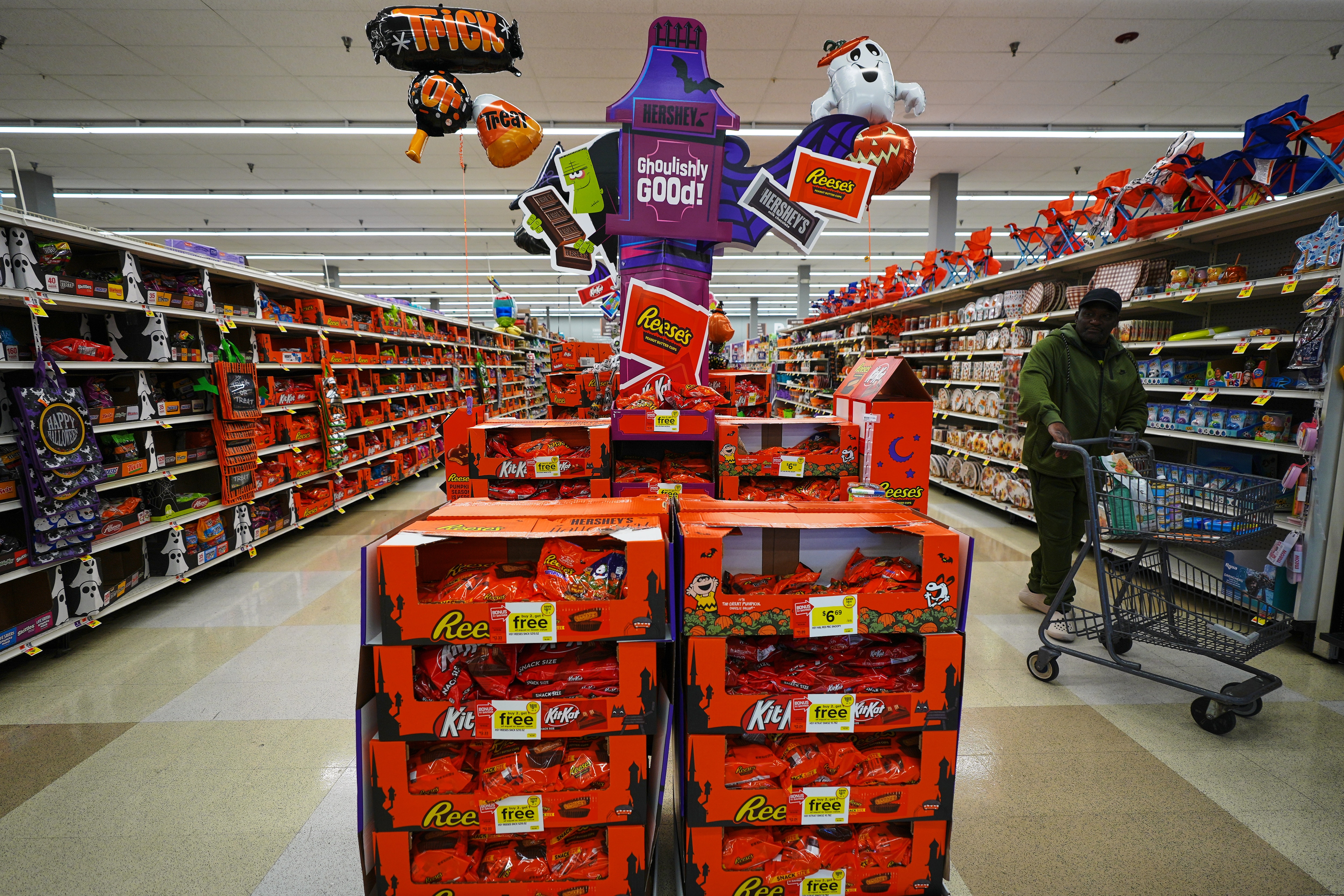 A shopper walks by a Halloween candy display at a Giant grocery store, Thursday, Oct. 22, 2026, in Dundalk, Md. (AP Photo/Stephanie Scarbrough)