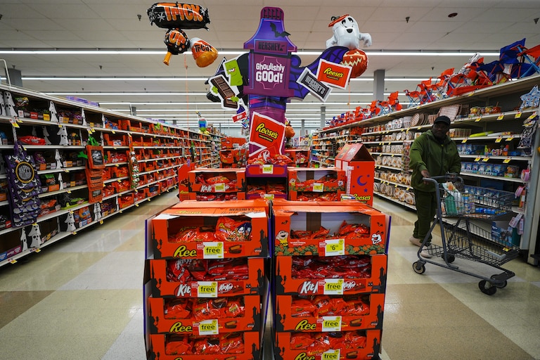 A shopper walks by a Halloween candy display at a Giant grocery store, Thursday, Oct. 22, 2026, in Dundalk, Md. (AP Photo/Stephanie Scarbrough)