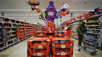 A shopper walks by a Halloween candy display at a Giant grocery store, Thursday, Oct. 22, 2026, in Dundalk, Md. (AP Photo/Stephanie Scarbrough)