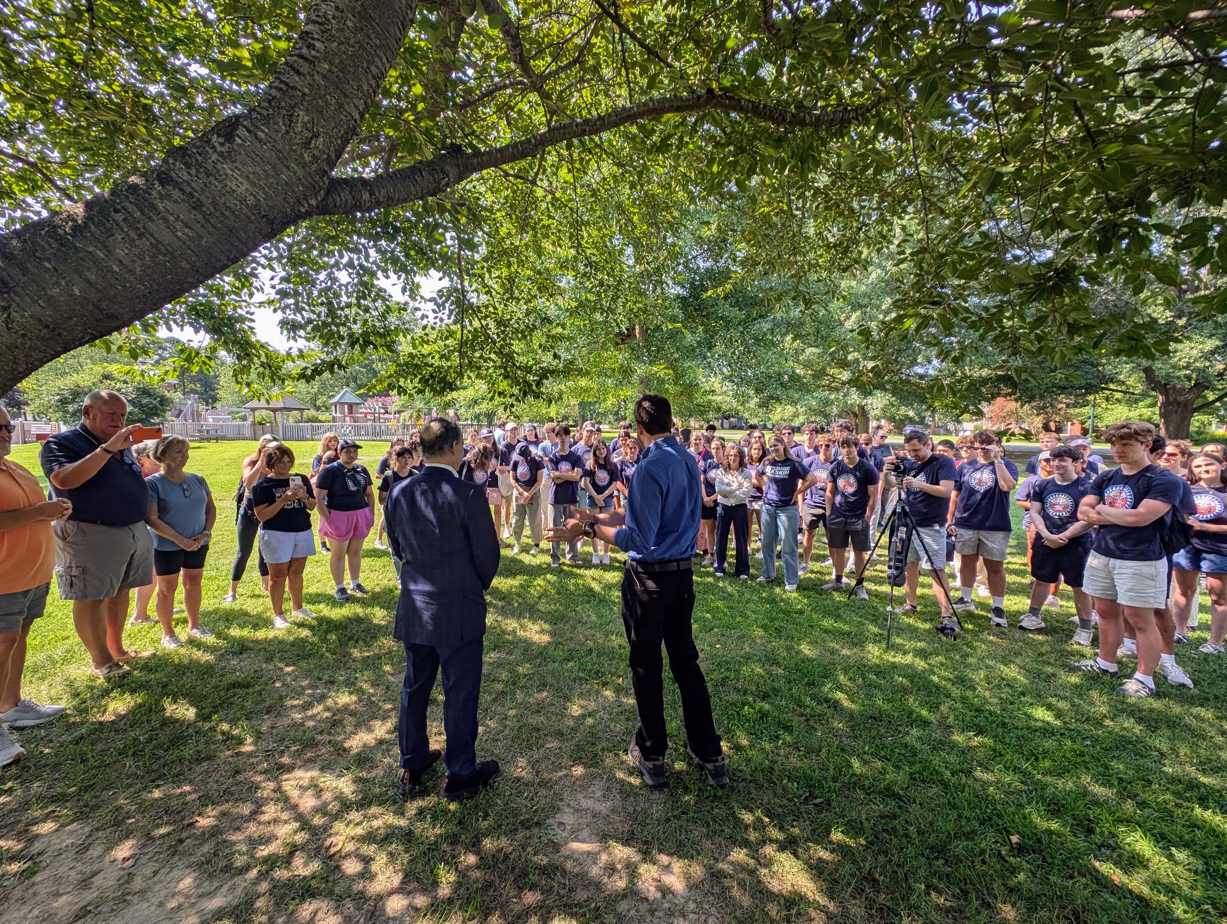 U.S. Rep. Jamie Raskin, left, and Dan Schwartz, the Democratic candidate for Congress in Maryland's 1st District, talk to student fellows from Democracy Summer during a voter canvass in Easton on July 26, 2026.