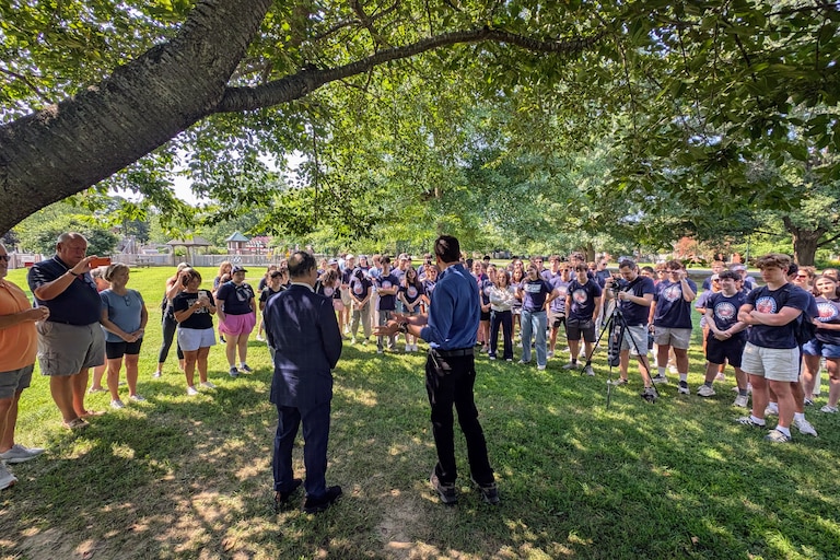 U.S. Rep. Jamie Raskin, left, and Dan Schwartz, the Democratic candidate for Congress in Maryland's 1st District, talk to student fellows from Democracy Summer during a voter canvass in Easton on July 26, 2026.