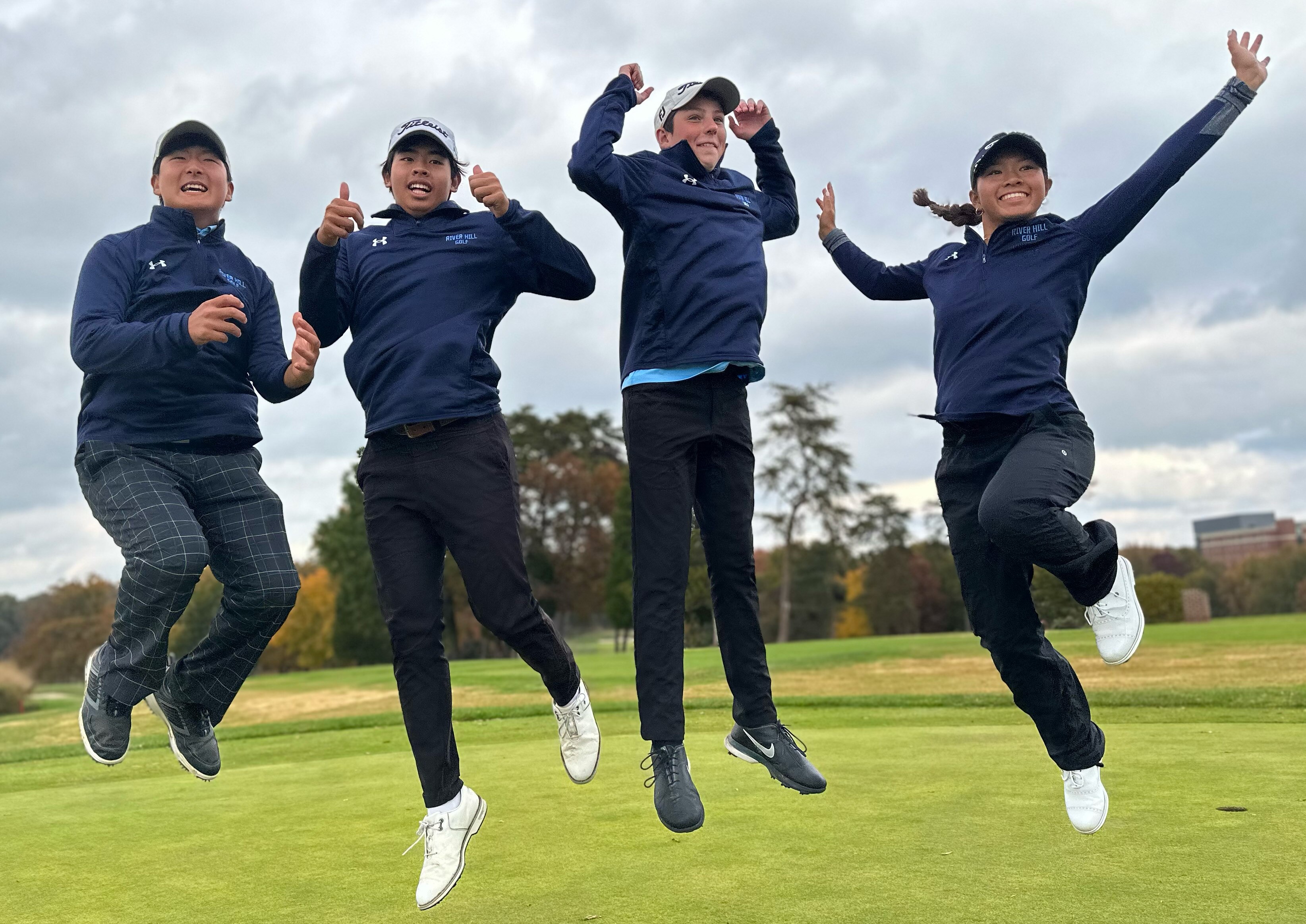 River Hill golfers (from left) Justin Choi, Benjamin Siriboury, Mark Berg and Helen Yeung leap for joy after winning the 3A/4A state golf team championship on Wednesday at the University of Maryland golf course.