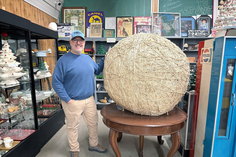 Chris Linsenbigler of Stoner’s Auction in Glen Rock, Pennsylvania poses with a large ball of string from the former Haussner’s restaurant.
