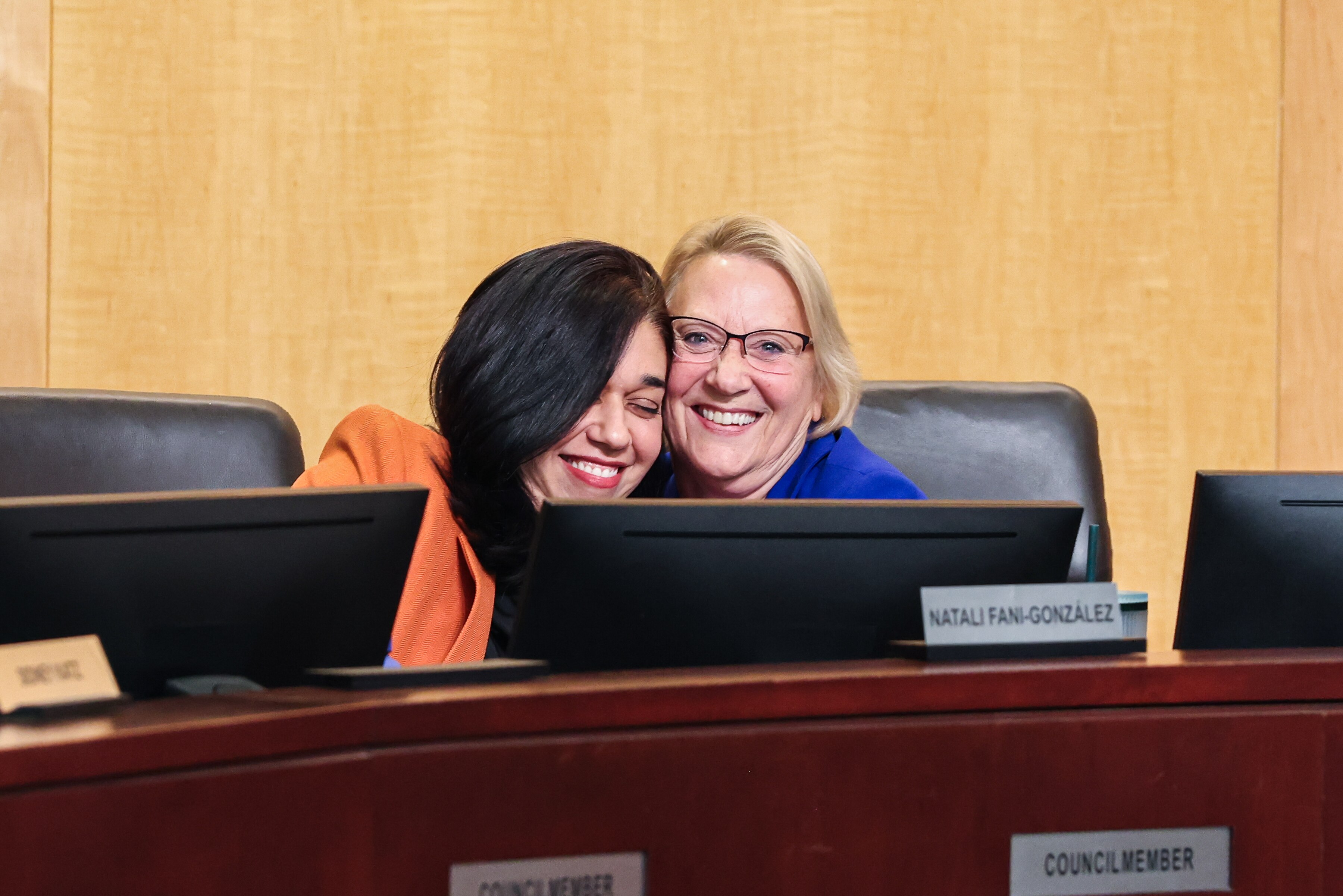 Council member Marilyn Balcombe, right, hugs council member Natali Fani-González at a meeting of the Montgomery County Council in Rockville on Tuesday, December 2, 2025. Fani-González will serve as the council’s next president after councilmembers unanimously voted Tuesday.