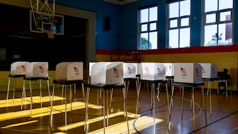 People cast their votes at Liberty Elementary, located at 3901 Maine Avenue in Baltimore, on Tuesday. At 6:30 p.m., the polling location was empty save for a few voters.