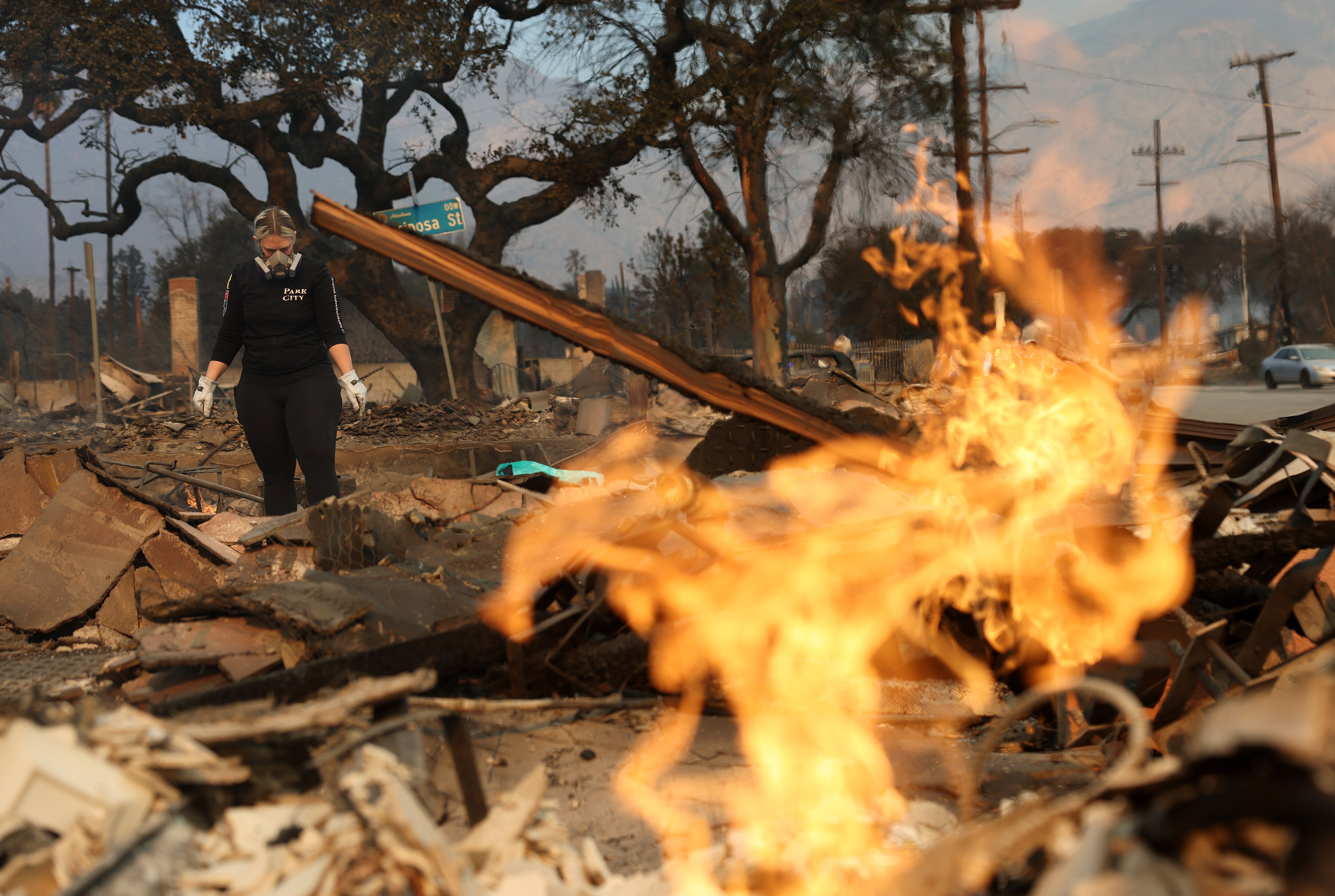 A resident inspects the remains of her home that was destroyed by the Eaton Fire on January 09, 2025 in Altadena, California.