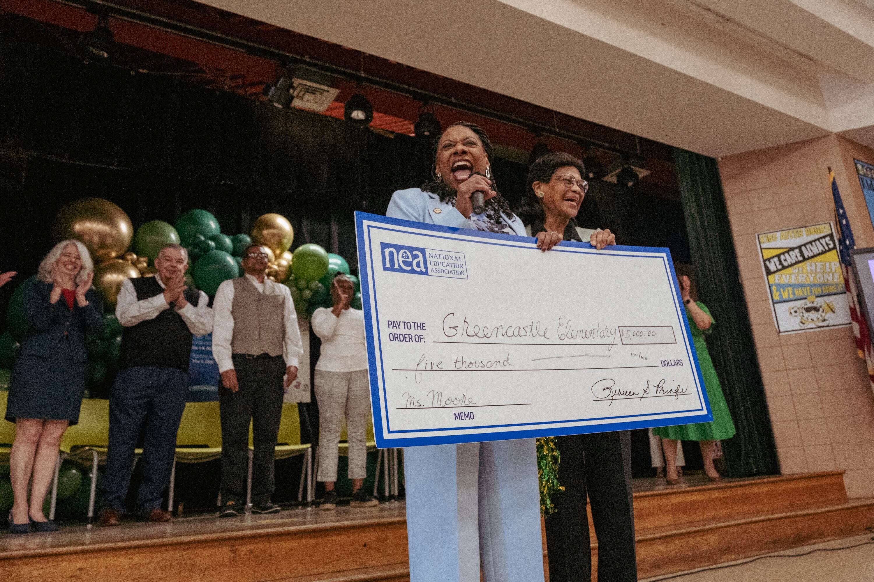 National Education Association president Becky Pringle, left, surprises second grade teacher Estelle Moore with a check for $5,000 during a morning assembly program at Greencastle Elementary School on Tuesday.