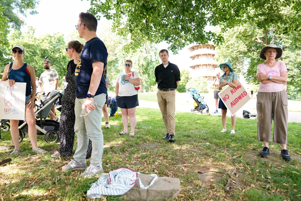 Baltimore City Council member Mark Parker, center, attends a rally with other protesters at Patterson Park in Baltimore, Md. on Friday, June 12, 2026. The group of community members and parents gathered a day after U.S. Immigration and Customs Enforcement arrested a student’s parents on Commodore John Rodgers Elementary/Middle School’s temporary campus in East Baltimore.