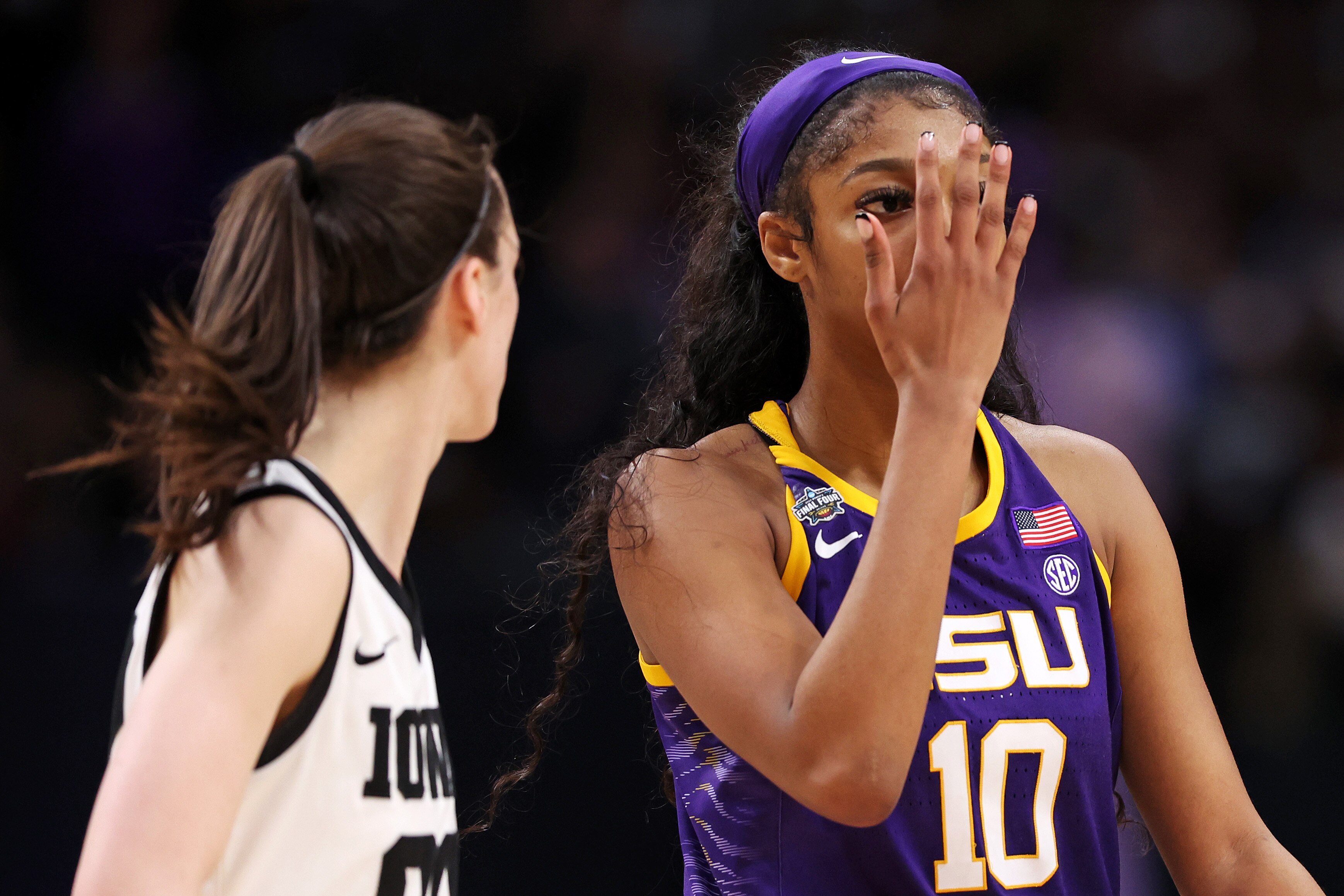 Angel Reese #10 of the LSU Lady Tigers hold up her hand to Caitlin Clark #22 of the Iowa Hawkeyes during the fourth quarter of the 2023 NCAA Women's Basketball Tournament championship game at American Airlines Center on April 2, 2023 in Dallas, Texas.