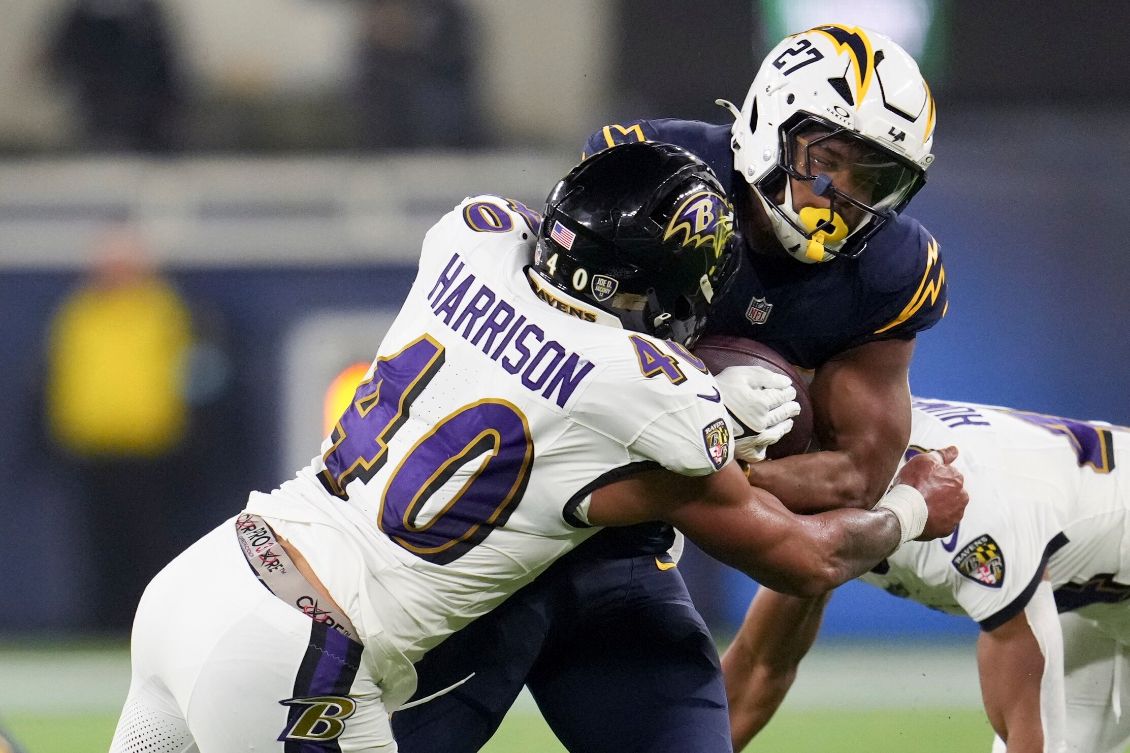 Los Angeles Chargers running back J.K. Dobbins (27) is tackled by Baltimore Ravens linebacker Malik Harrison (40) during the first half of an NFL football game Monday, Nov. 25, 2024, in Inglewood, Calif. (AP Photo/Eric Thayer)
