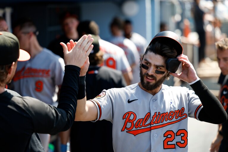 Blaze Alexander is greeted by teammates after scoring on a double by Jeremiah Jackson during the seventh inning of Sunday's game against the Los Angeles Dodgers.
