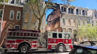 SATURDAY, MAY 30, 2026 - A Baltimore City fire truck at the site of the fatal house fire in the 2200 block of Guilford Avenue in Barclay. The three-alarm fire occurred on Thursday.