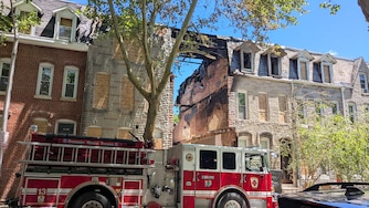 SATURDAY, MAY 30, 2026 - A Baltimore City fire truck at the site of the fatal house fire in the 2200 block of Guilford Avenue in Barclay. The three-alarm fire occurred on Thursday.