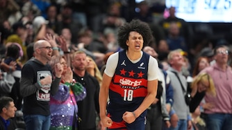 Washington Wizards forward Kyshawn George (18) reacts after hitting a 3-point basket in the second half of an NBA basketball game Saturday, March 15, 2025, in Denver.