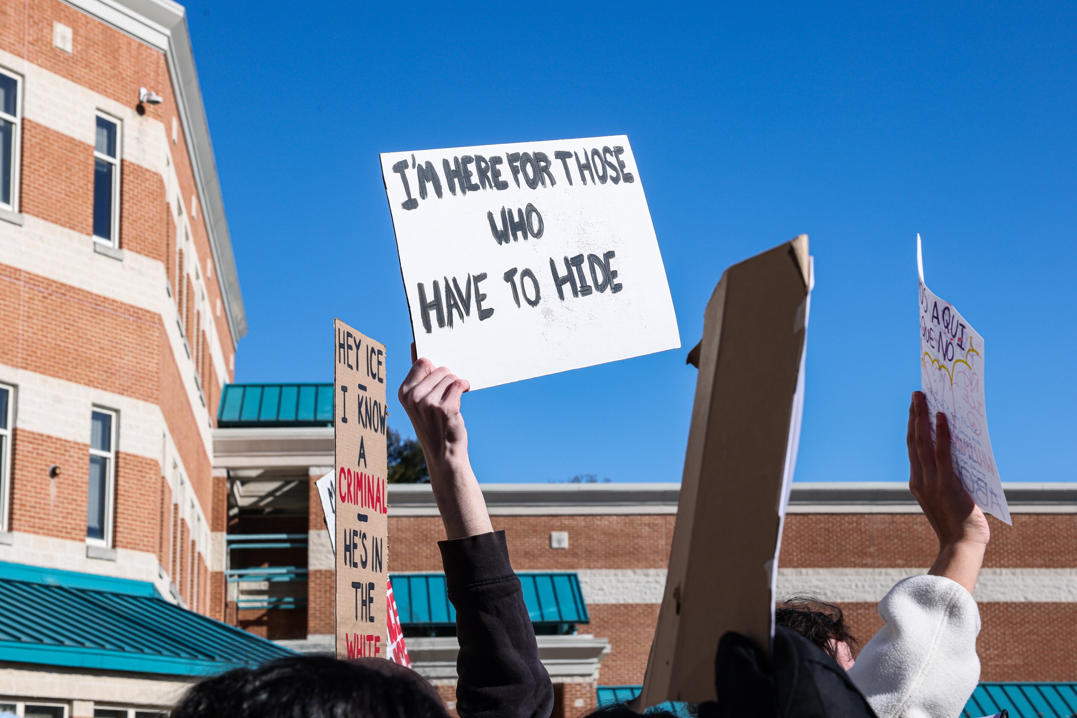 Walt Whitman High School students hold signs during a walkout at the school in Bethesda on Tuesday.
