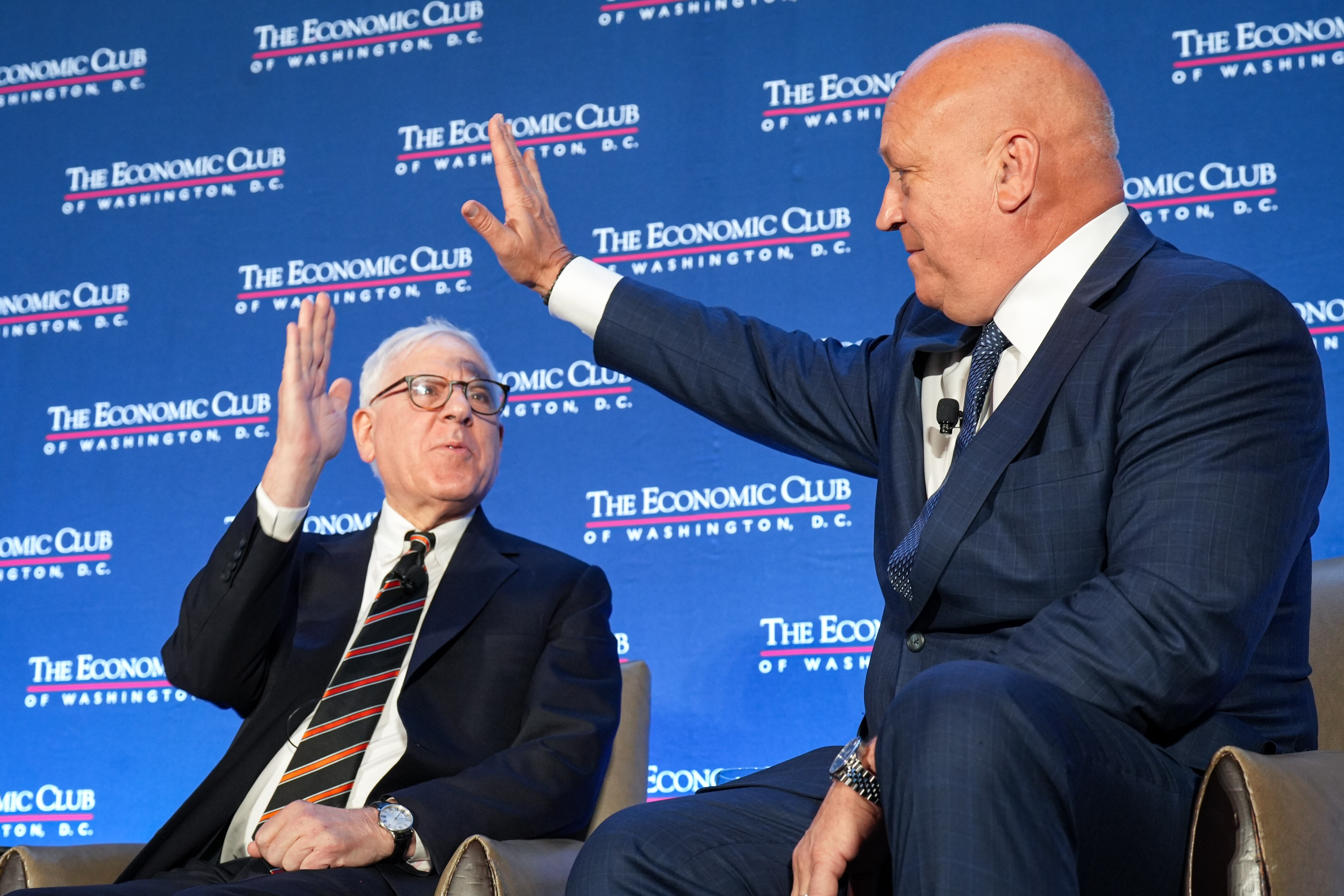 Baltimore Orioles owner David Rubenstein (left) and Hall of Famer Cal Ripken Jr. high-five during a panel on April 30.