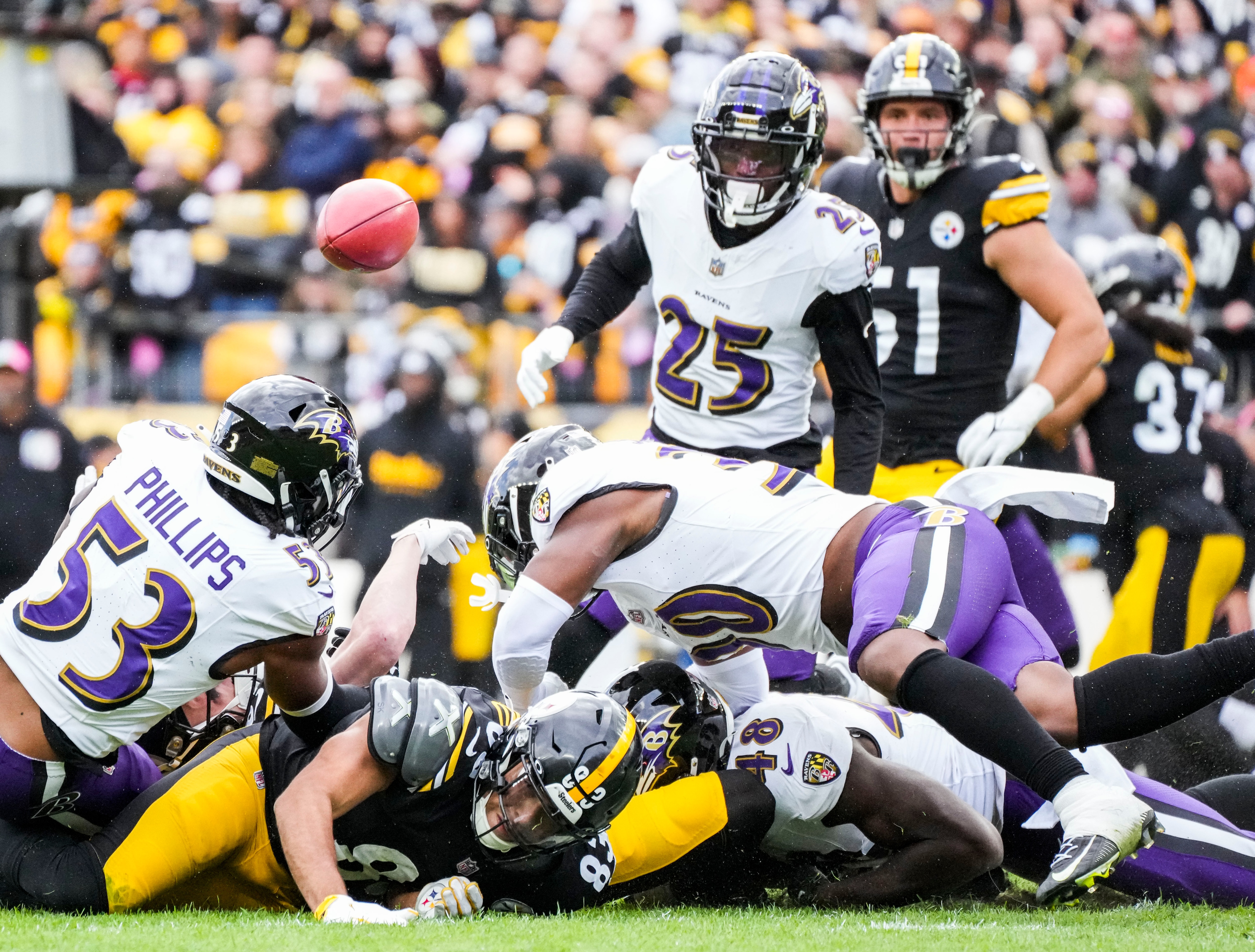 Steelers tight end Connor Heyward loses the ball in a crowd of Ravens defenders.