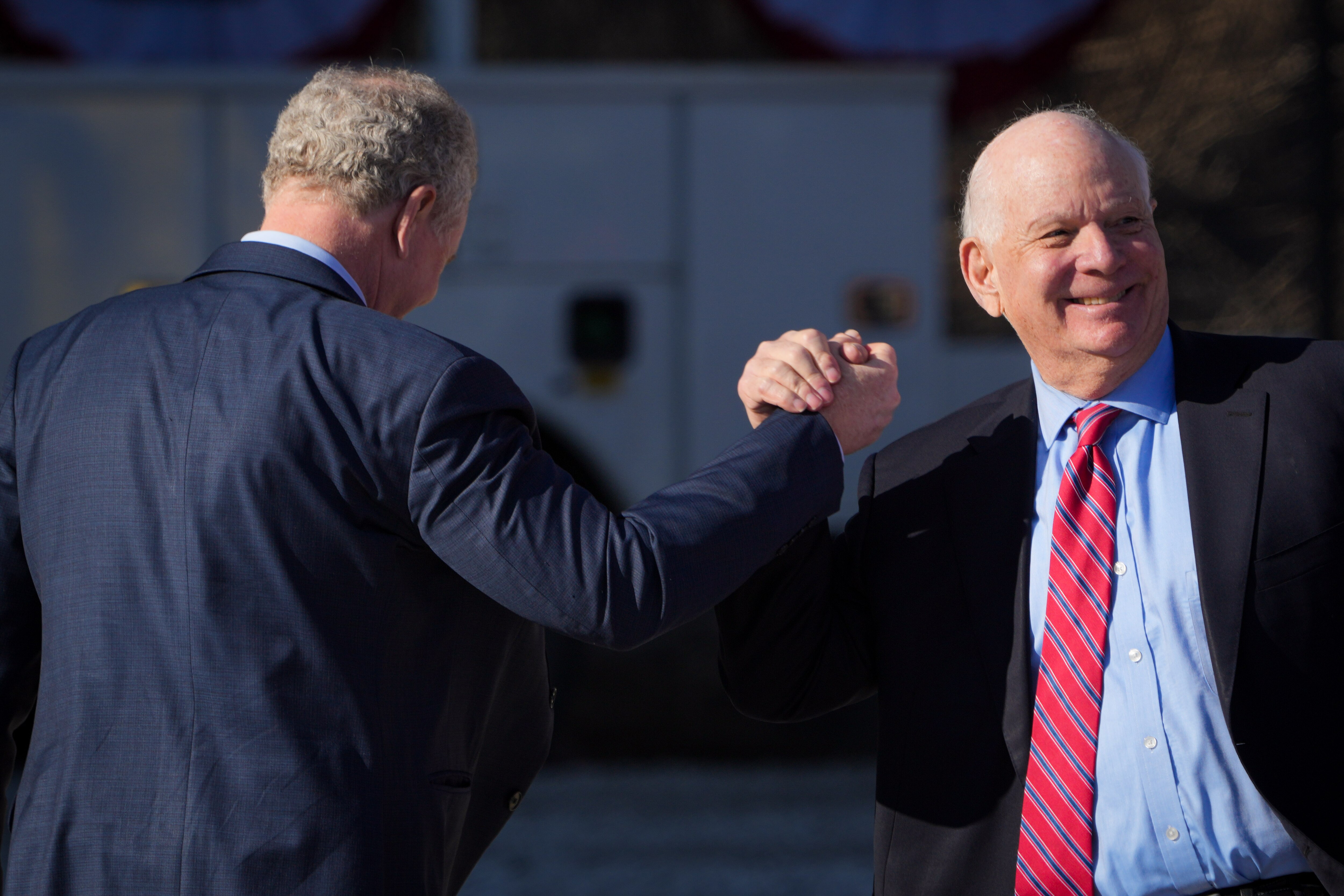 U.S. Sen. Ben Cardin shakes hands with U.S. Sen. Chris Van Hollen before President Joe Biden’s visit to Baltimore on Jan. 30, 2023. Cardin, Van Hollen and U.S. Rep. Steny Hoyer are among the Maryland members of Congress touting Maryland sites for a new FBI headquarters.