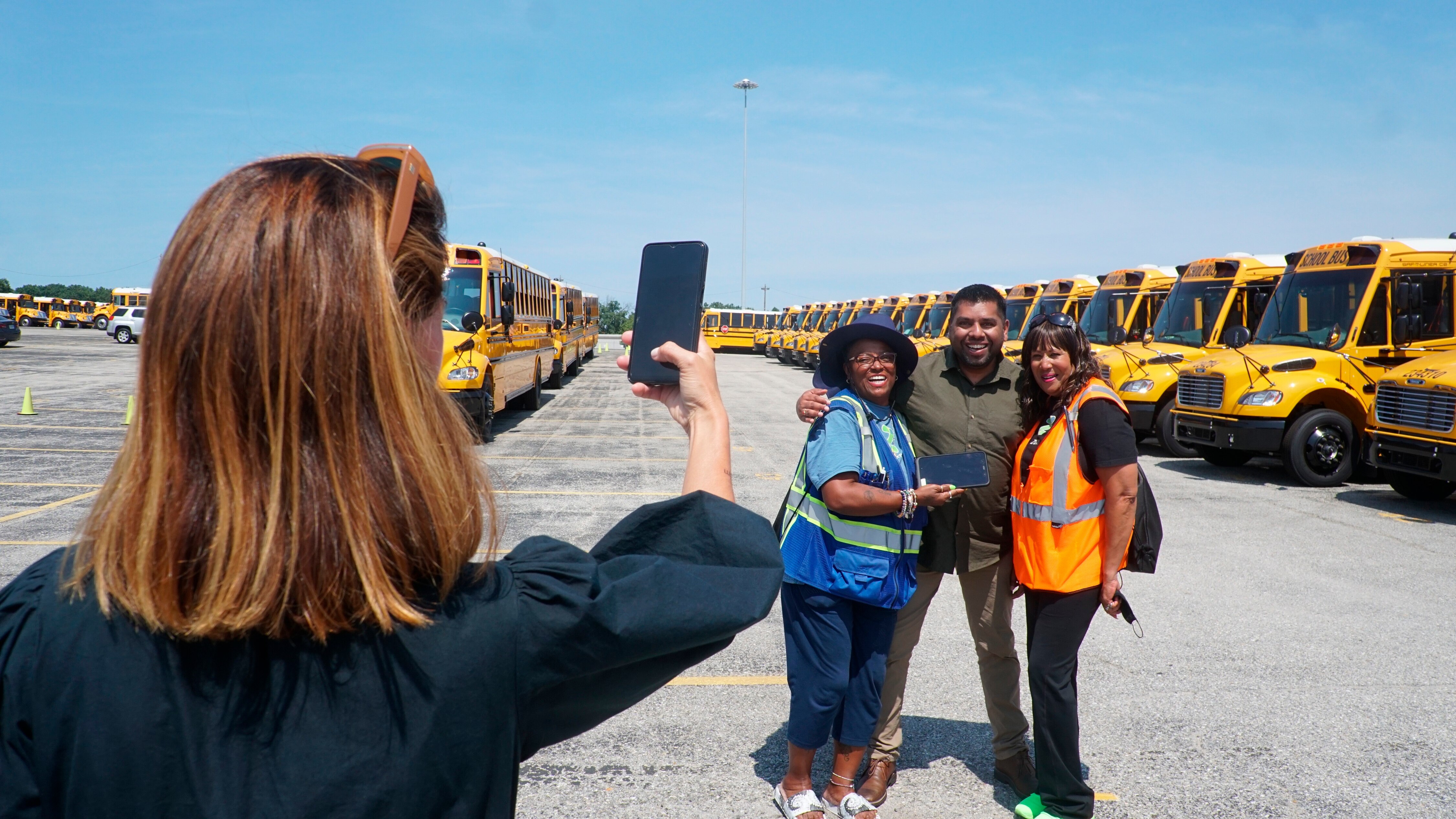 Donna McSee and Jackie Scott, drivers for Howard County Public Schools, pose for a photo with Zum CEO Vivek Garg.