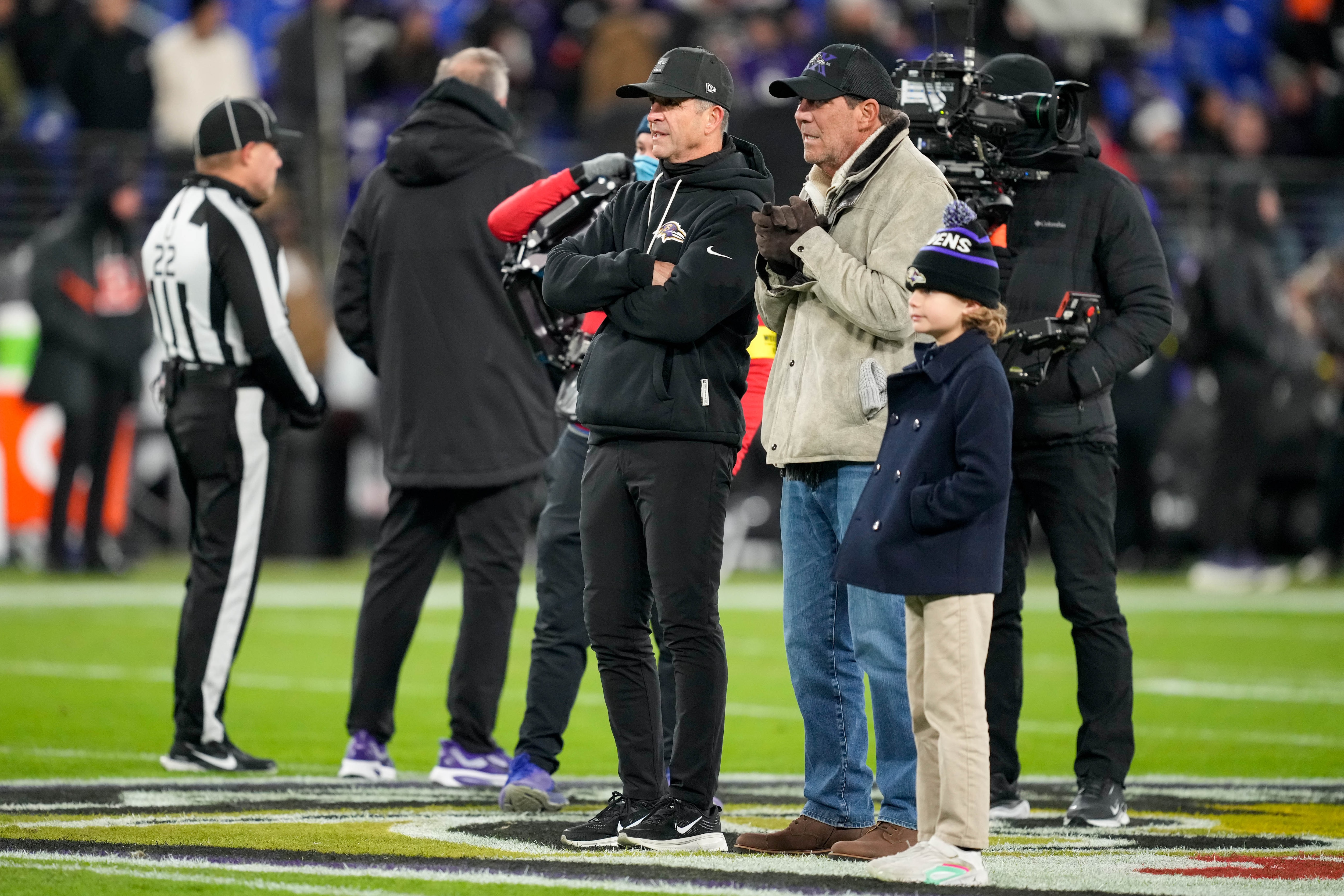Ravens coach John Harbaugh, center, and team owner Steve Bisciotti watch the players during pregame last month.