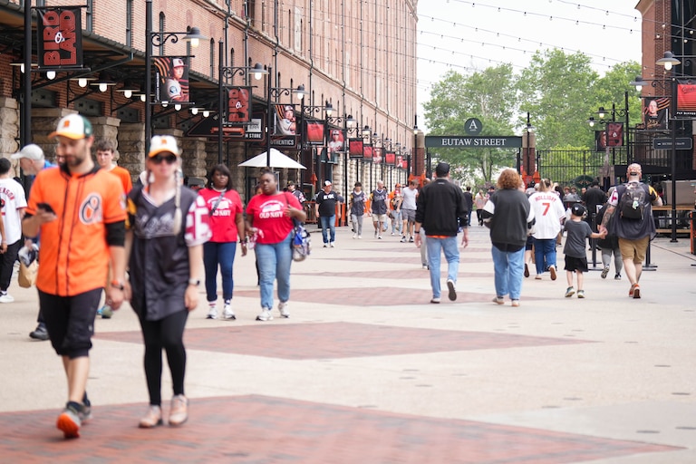 Baltimore Orioles fans walk along Eutaw Street during a baseball game against the Tampa Bay Rays at Oriole Park at Camden Yards in Baltimore, Md. on Monday, May 25, 2026.