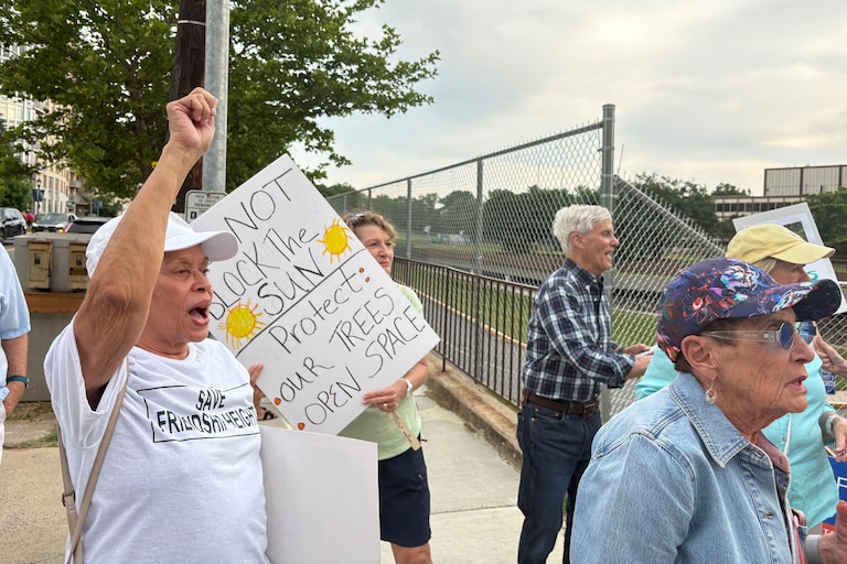 Residents rally outside of the former GEICO headquarters in Friendship Heights on June 9 to call for a stop to the development proposed on the site.