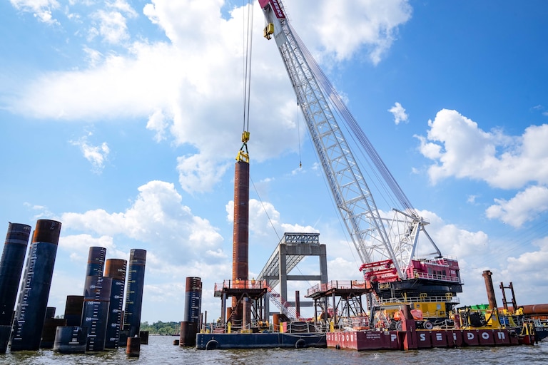 Piles are lifted by crane into the water next to an older section of the Francis Scott Key Bridge in Baltimore, Md. on Wednesday, August 26, 2026.