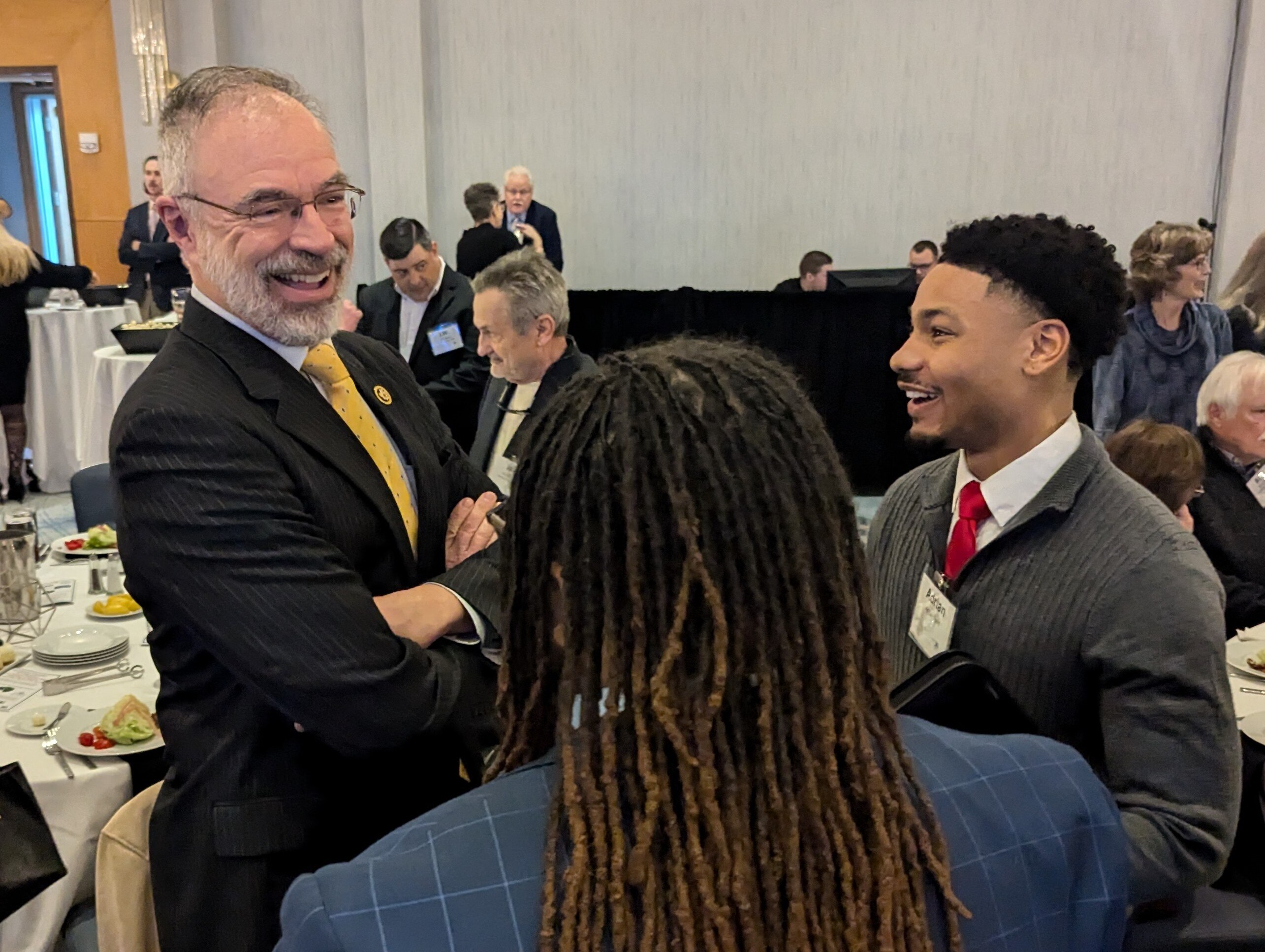 U.S. Rep. Andy Harris talks with Salisbury State University sophomore Adrian Todd, right, at the Dorchester County Chamber of Commerce in Cambridge, MD, on March 13, 2025.