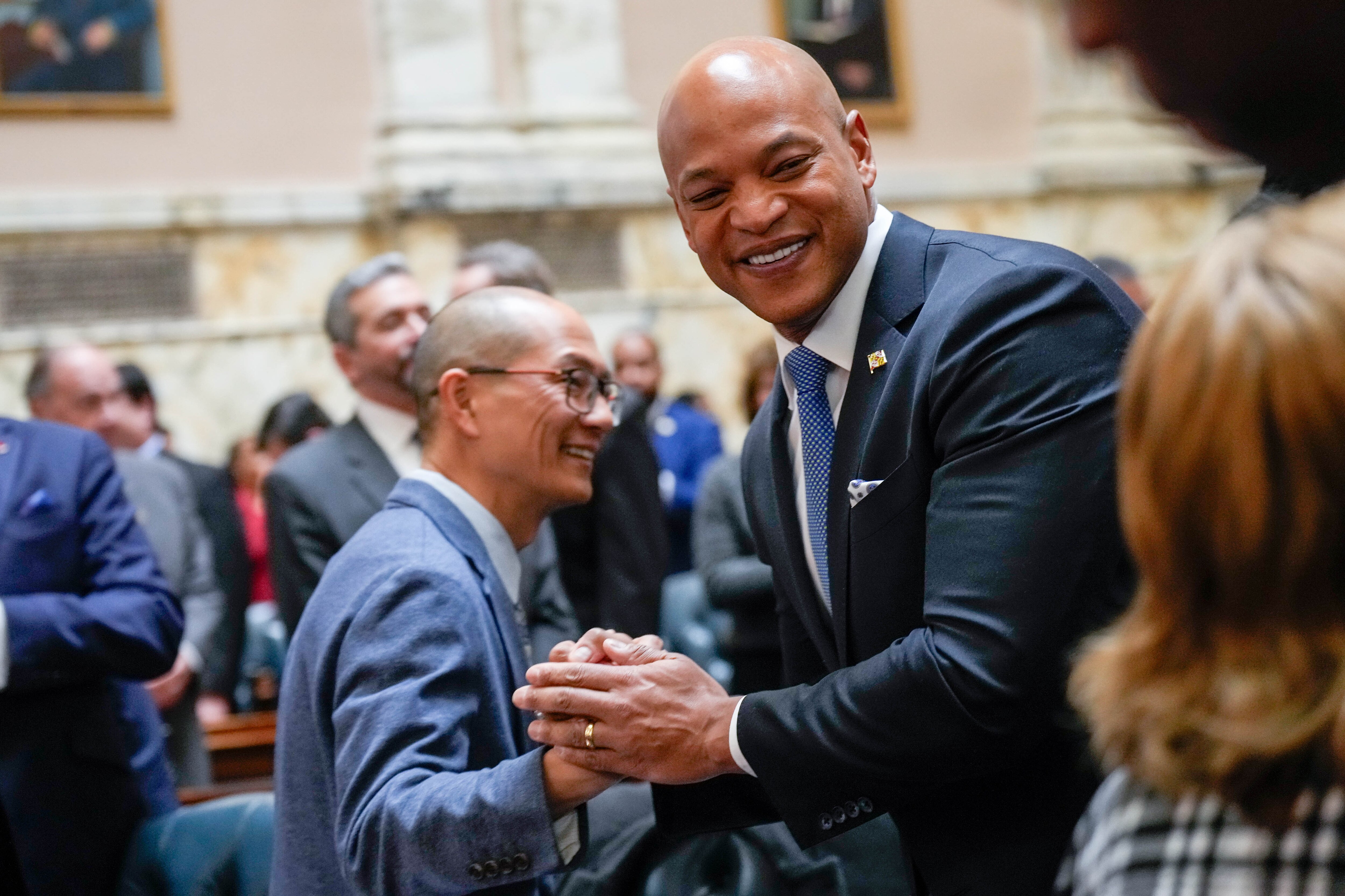 Gov. Wes Moore greets House Majority Leader David Moon as he arrives in the House Chamber to deliver his annual State of the State address on Wednesday.