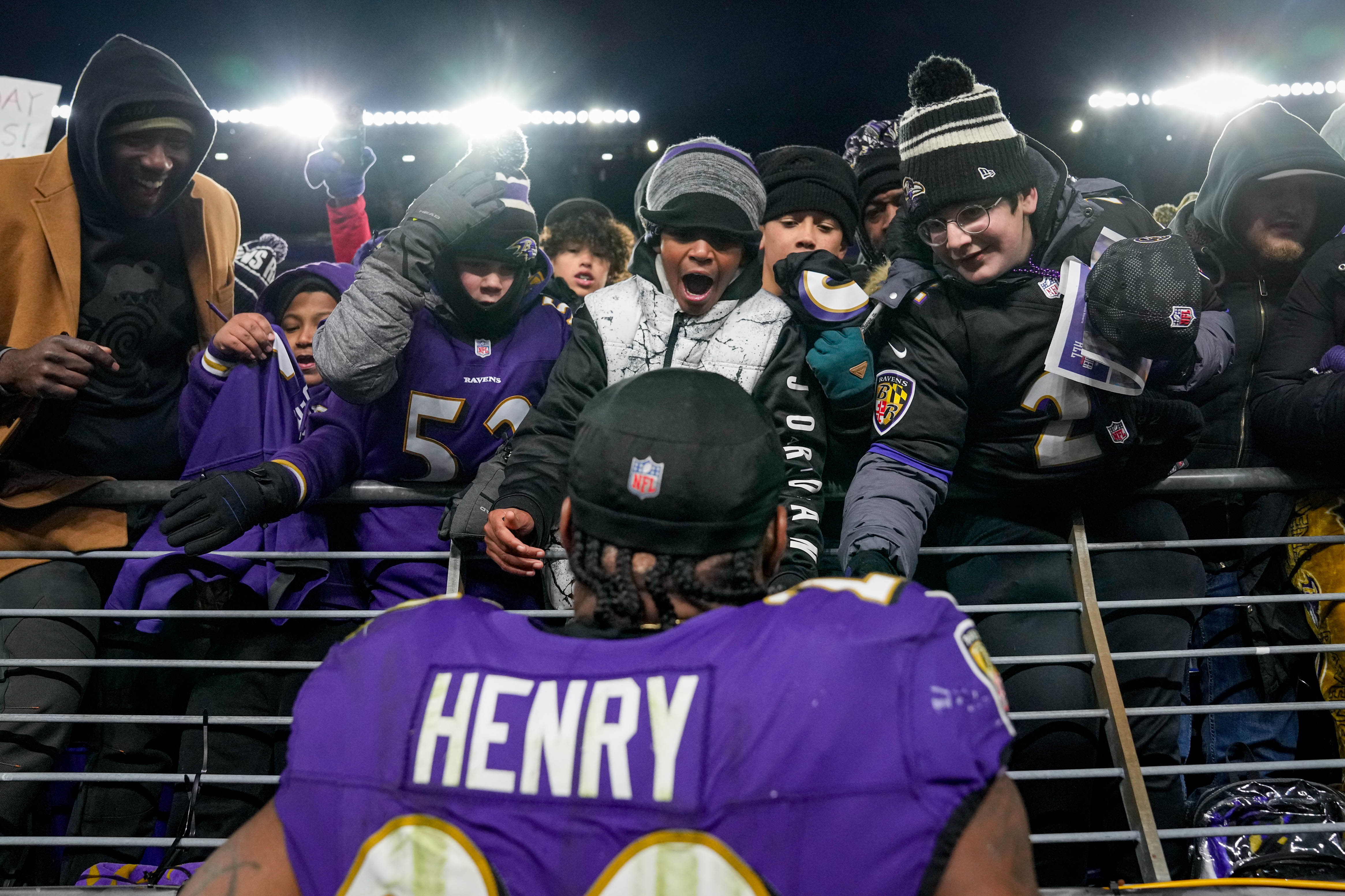 Baltimore Ravens running back Derrick Henry (22) signs autographs for fans after they won the game against the Cleveland Browns at M&T Bank Stadium in Baltimore, Md. on Saturday, January 4, 2025.