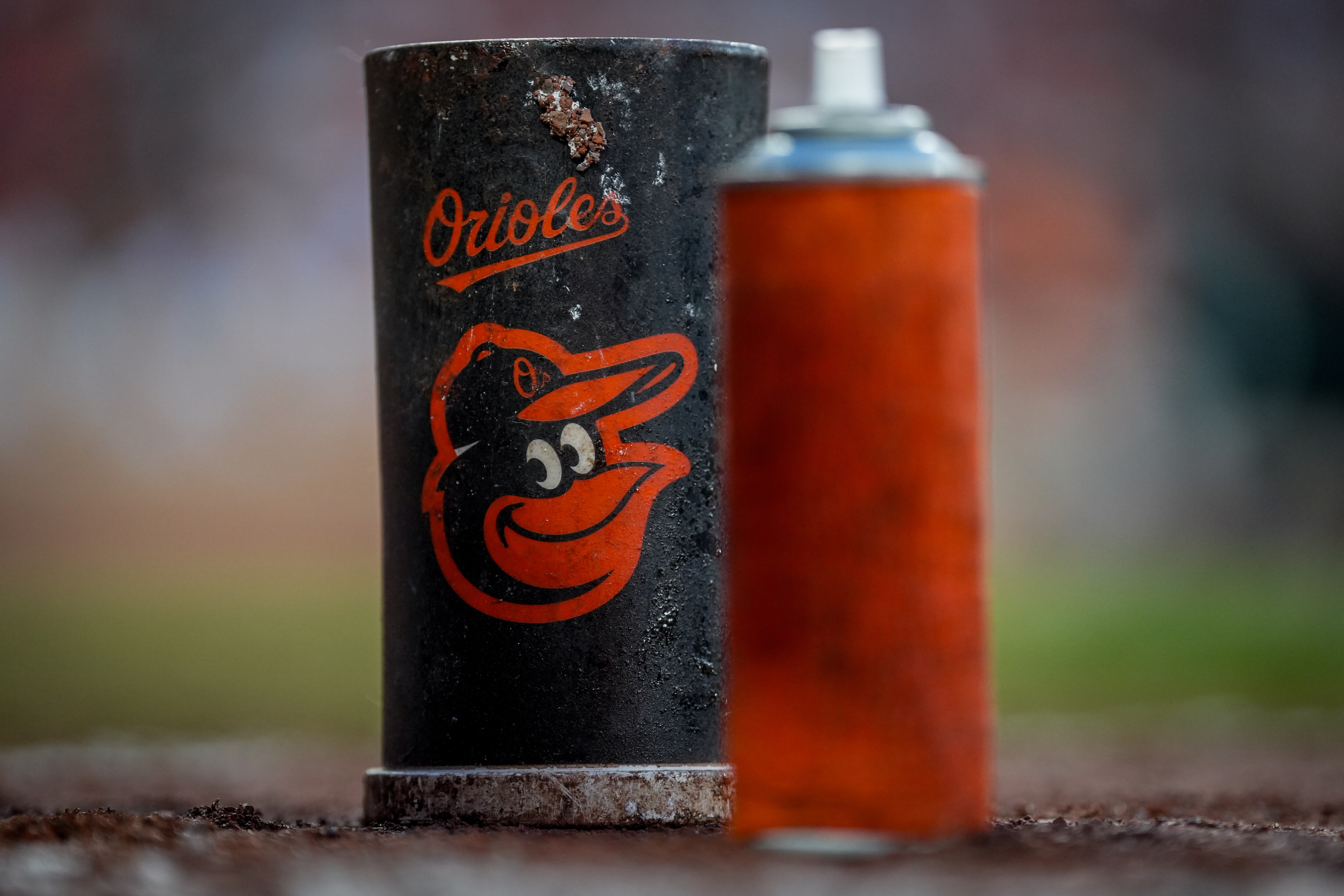 The Baltimore Orioles logo is on a baseball bat donut in the on-deck circle during a game against the Houston Astros at Oriole Park at Camden Yards in Baltimore on Aug. 8, 2023.