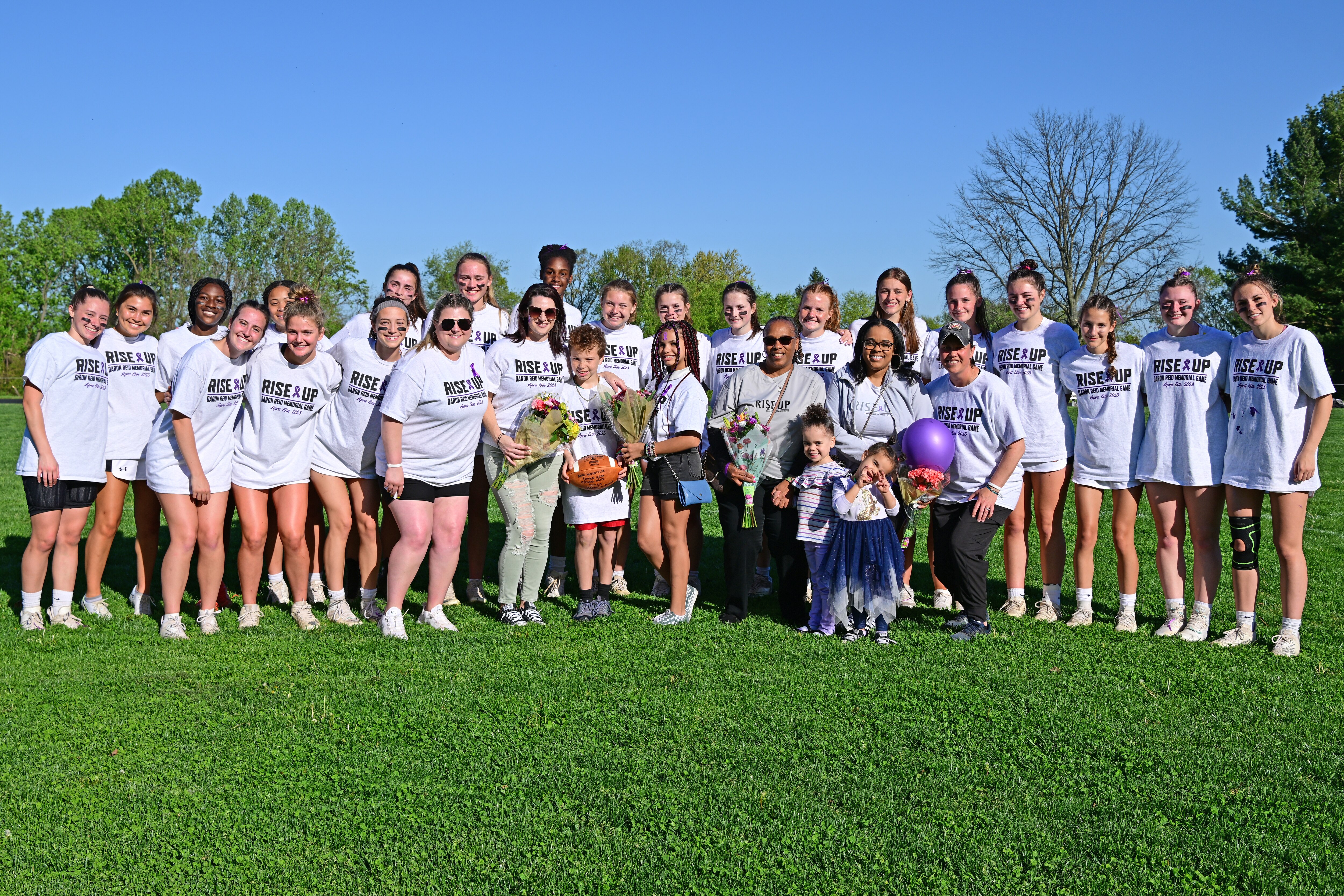 The widow of late Dulaney football coach Daron Reid, and her family, gathered with the Dulaney girls lacrosse team prior to Wednesday's game against rival Towson. Reid, who passed from pancreatic cancer in February, was honored prior to the game, which was celebrated as "The Rise Up Daron Reid Memorial Game."