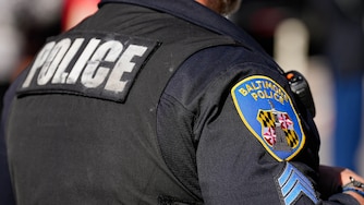 A Baltimore Police Department officer observes the 2025 Veterans Day parade in Baltimore, Md., on Saturday, November 8, 2025.