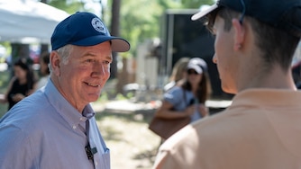 U.S. Senator Chris Van Hollen of Maryland speaks to a resident at the Polk County Streak Fry, held by the Polk County Democrats, at Water Works Park in Des Moines, Iowa on Saturday, September 13, 2025.