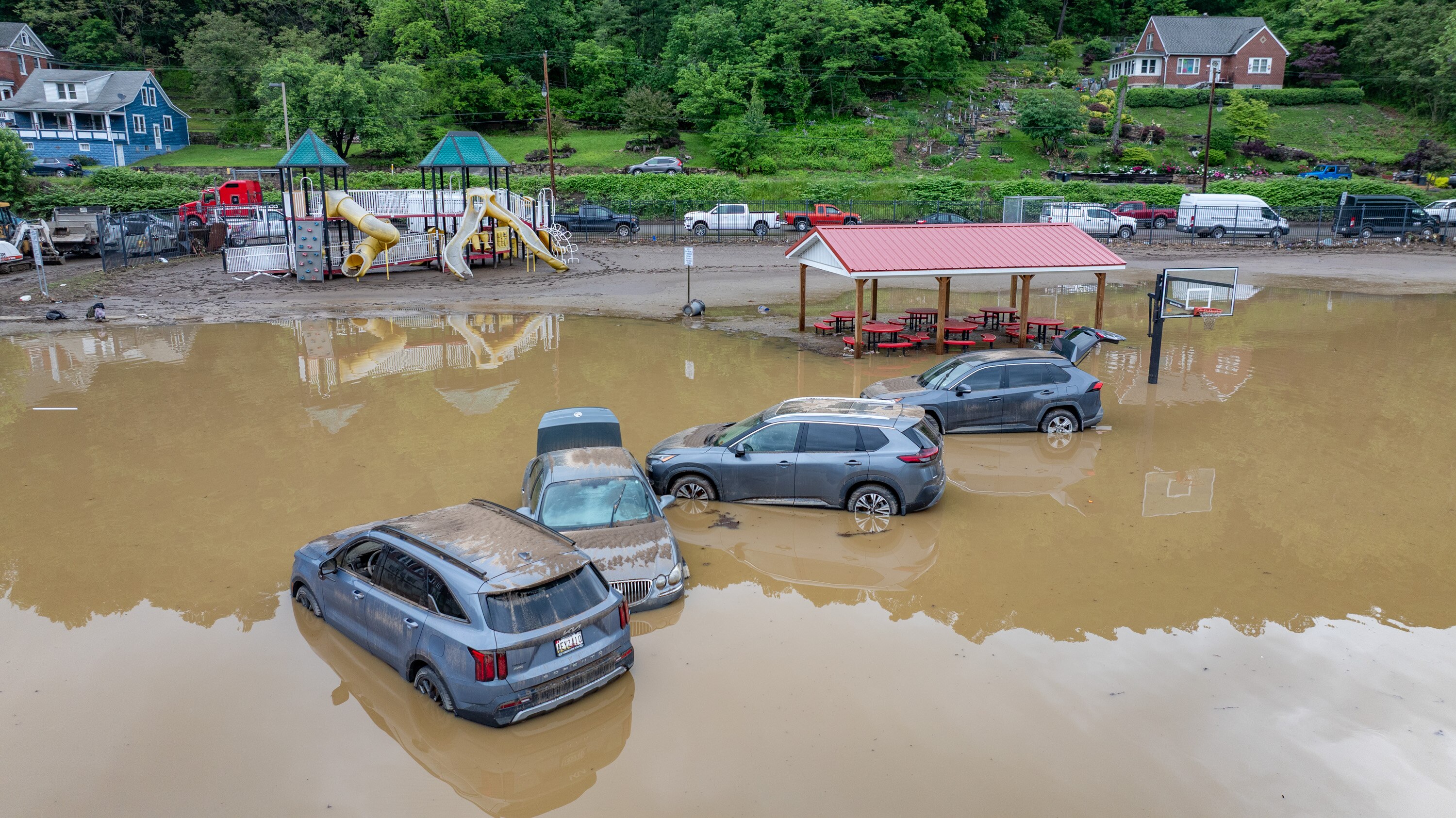 Waterlogged cars sit in the flooded parking lot of Westernport Elementary School after a catastrophic storm hit the area on Tuesday.