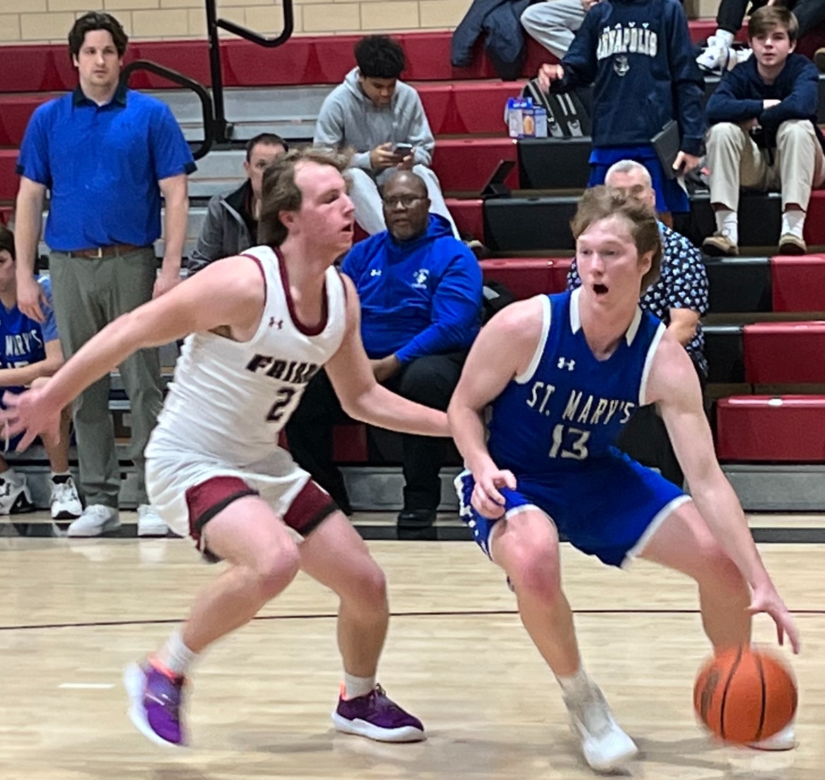 St. Mary's Grady Wolfe (right) looks to drive past Curley's Logan Nordick during Monday's MIAA B Conference basketball contest. The No. 12 Saints remained perfect in league play with a 62-53 victory over Friars in Baltimore City.
