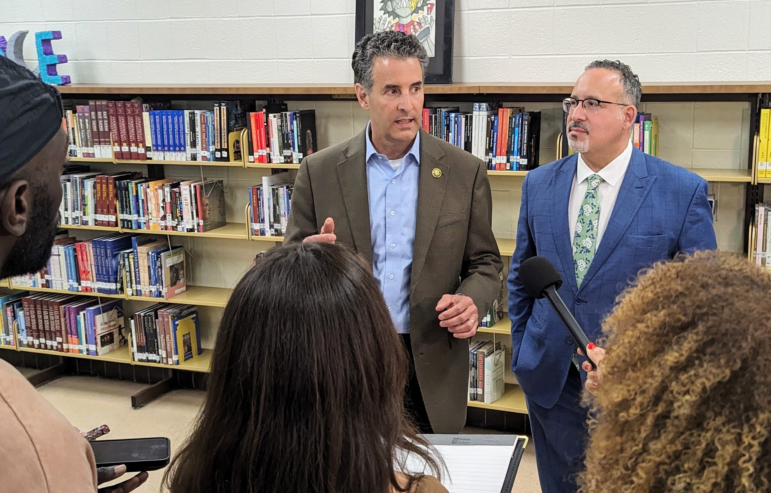 U.S. Rep. John Sarbanes, center, talks about mental health in education after an appearance at Annapolis High School on May 23 with U.S. Education Secretary Miguel Cardona. Cardona's press secretary kept calling it a media scrum, although it was one reporter, a student, a school board video team and me.