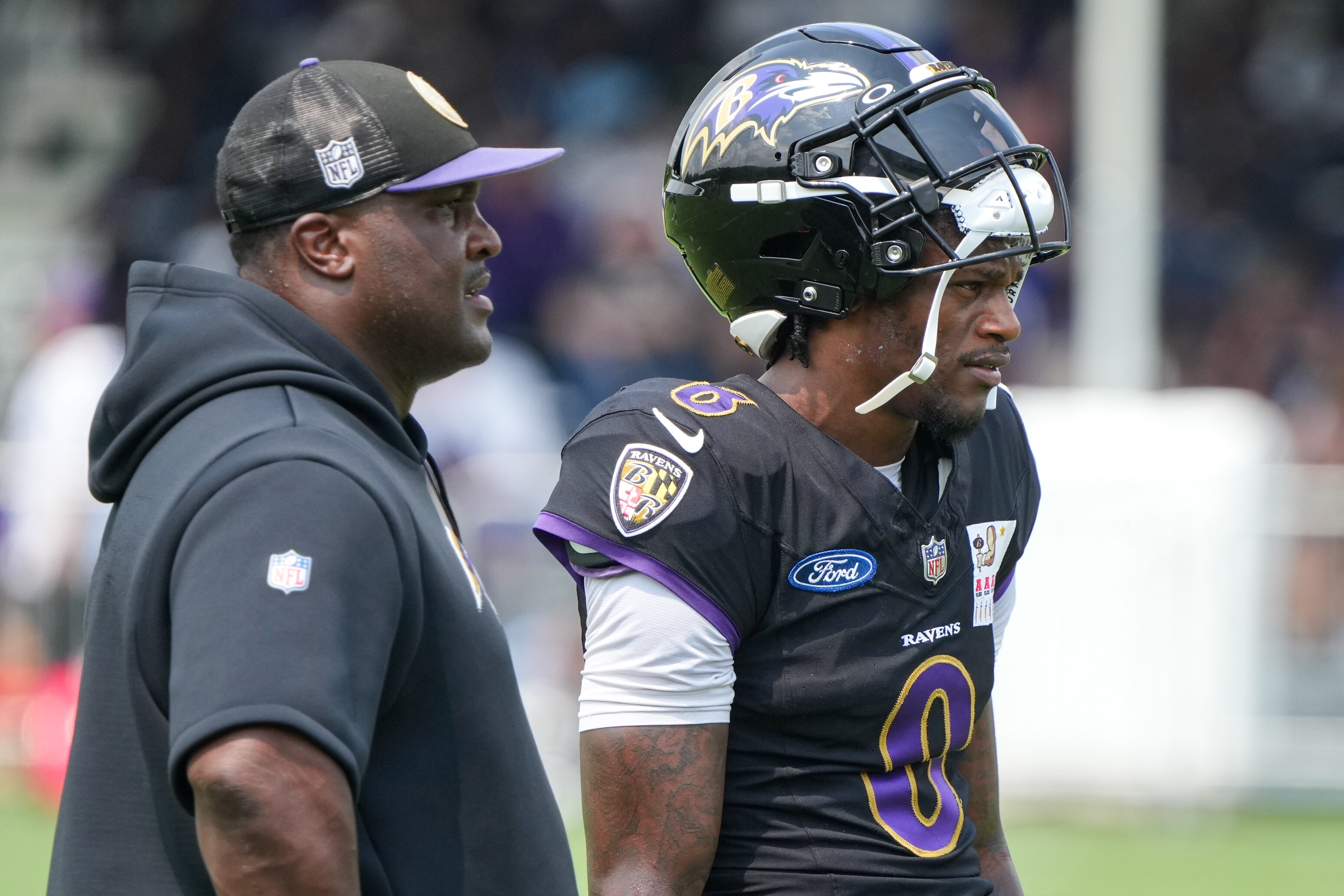Quarterback Lamar Jackson (8) takes a break between drills on Aug. 6.