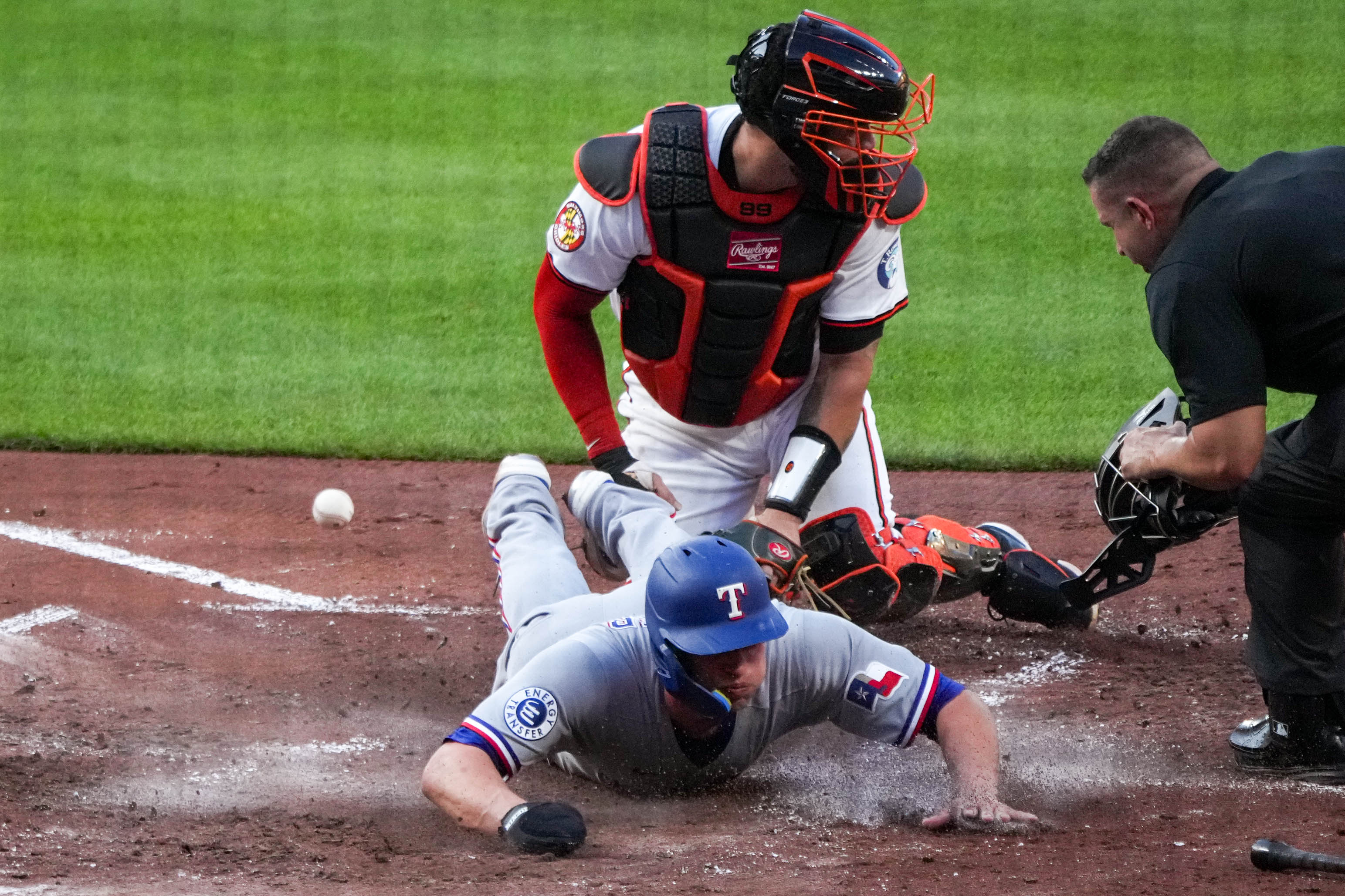 Texas Rangers shortstop Corey Seager slides home safely as Baltimore Orioles catcher Gary Sánchez can’t hang onto the ball at home plate on Tuesday.