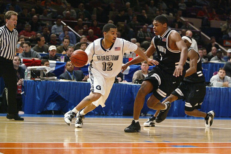 NEW YORK - MARCH 6: Kevin Braswell #12 of the Georgetown Hoyas drives around Ryan Gomes #3 of the Providence Friars during the first round of the Big East Tournament at Madison Square Garden in New York, New York on March 6, 2002. The Hoyas won 68-67.