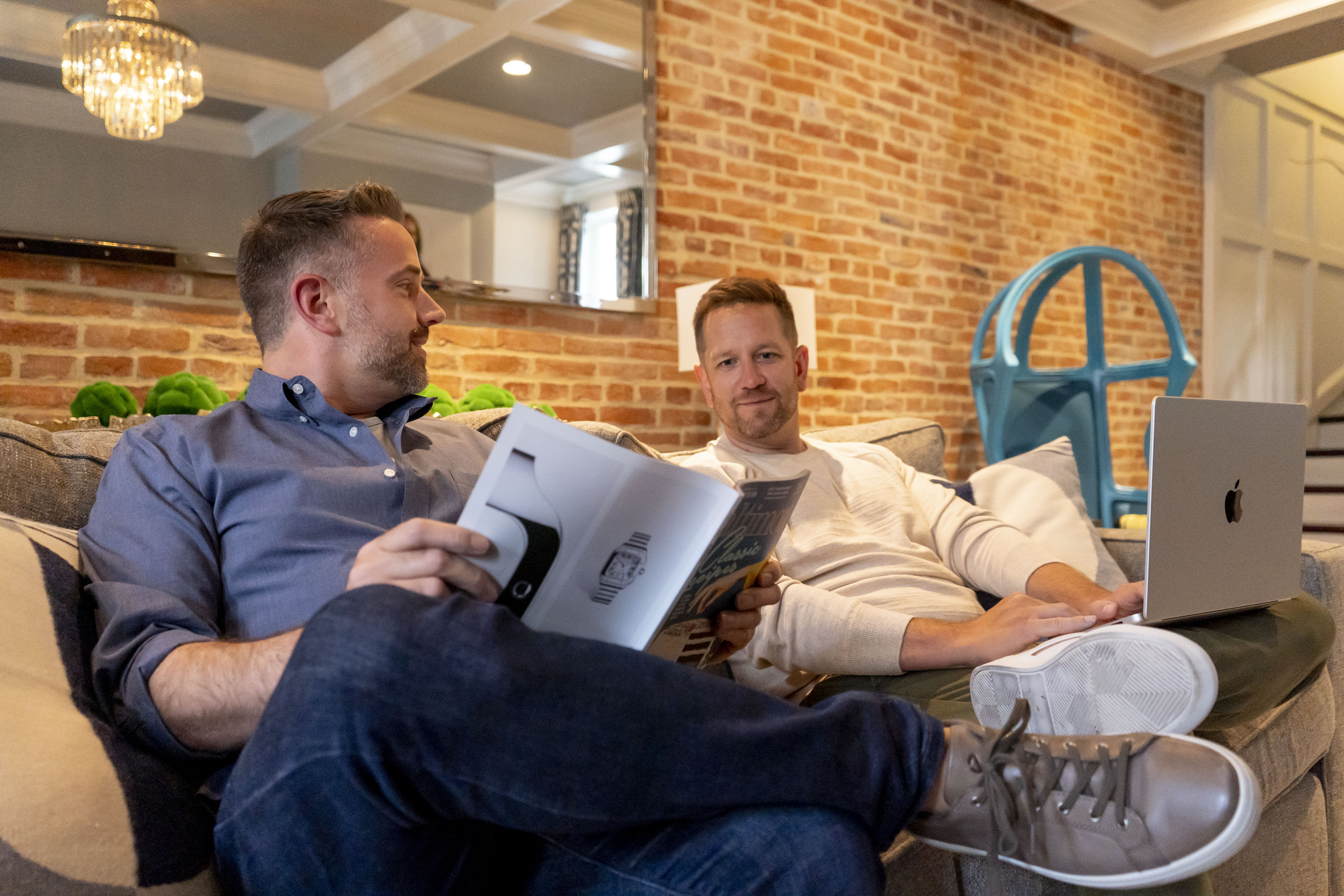 Stanford Kimmel shows Chris Franzoni an article in the magazine he is reading.
