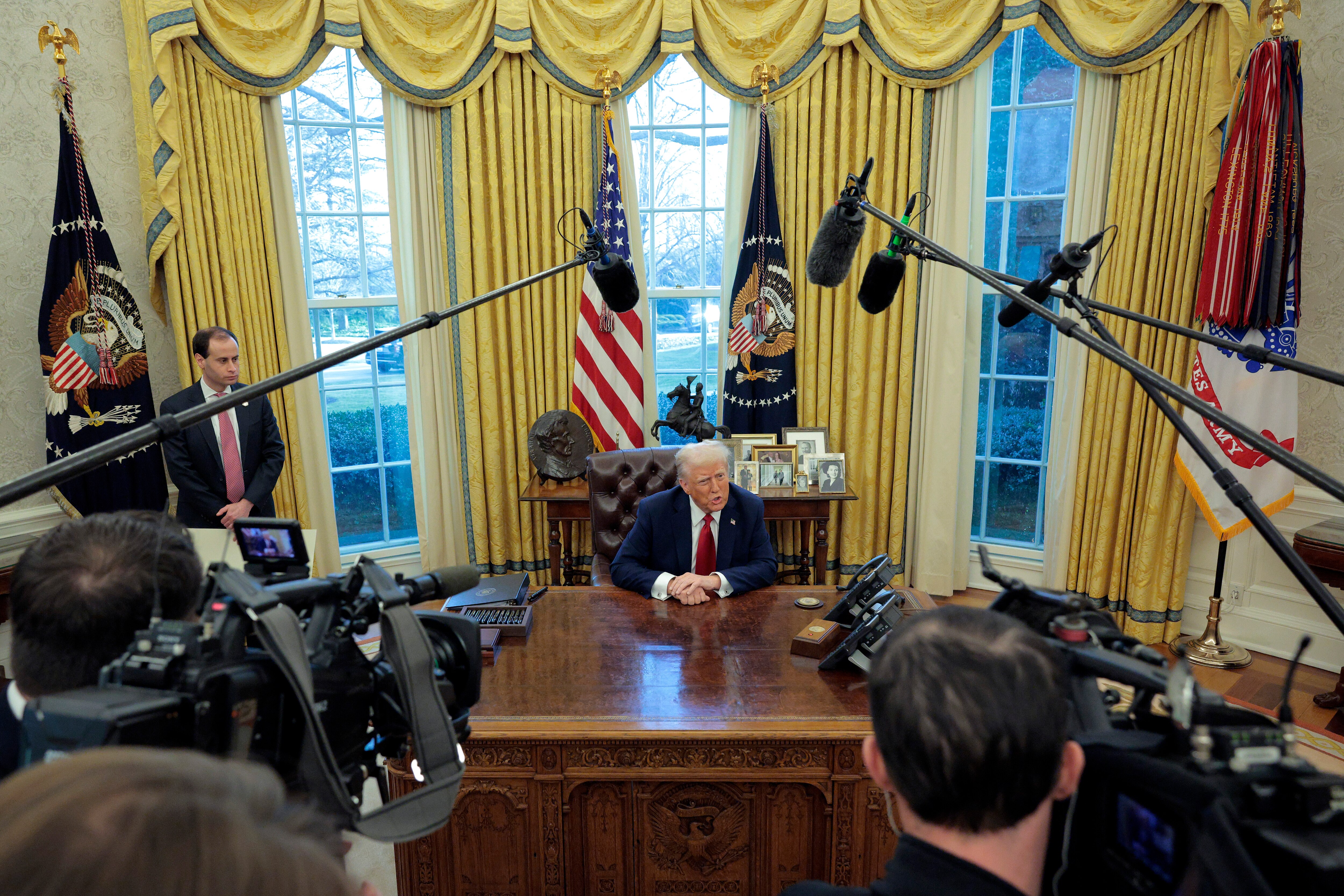 WASHINGTON, DC - JANUARY 30: U.S. President Donald Trump talks to reporters from the Resolute Desk after signing an executive order to appoint the deputy administrator of the Federal Aviation Administration in the Oval Office at the White House on January 30, 2025 in Washington, DC. Trump also signed a memorandum ordering an immediate assessment of aviation safety and ordering an elevation of what he called “competence” over “D.E.I.”
