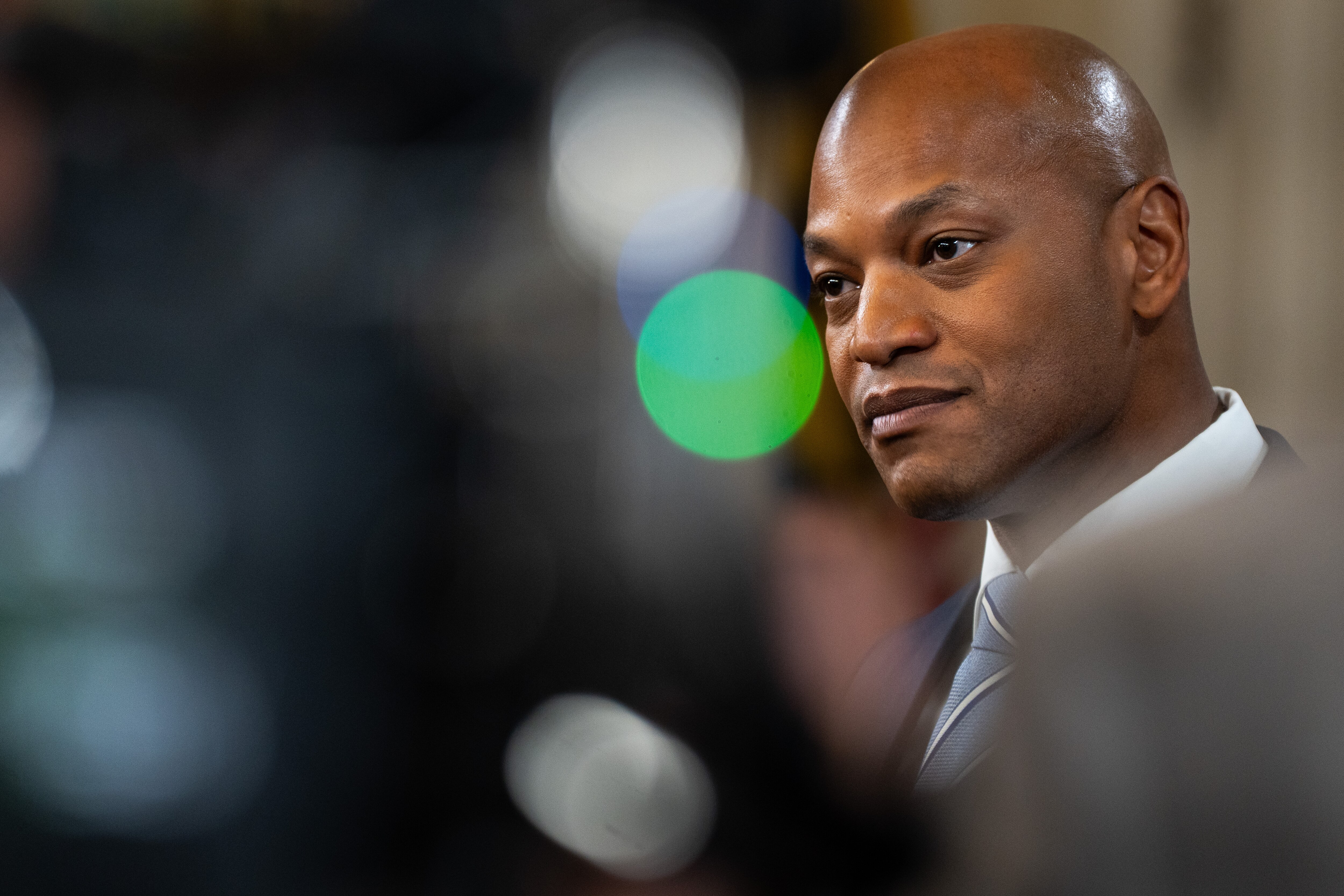 Gov. Wes Moore listens to a reporter’s question during a press gaggle in the State House on the opening day of the Maryland general assembly in Annapolis, Md. on Wednesday, Jan. 10, 2024.
