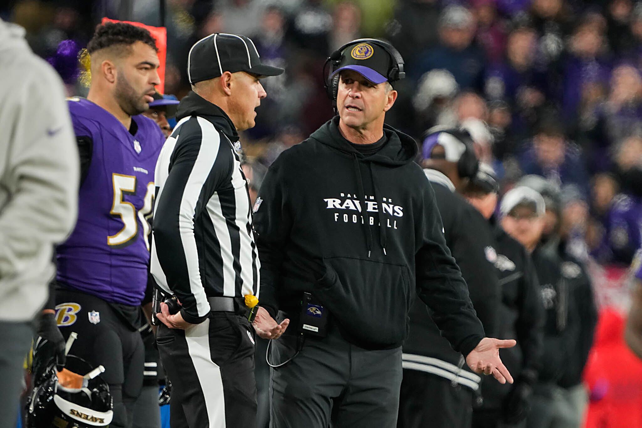 Ravens coach John Harbaugh argues with an official after receiver Zay Flowers was called for taunting.