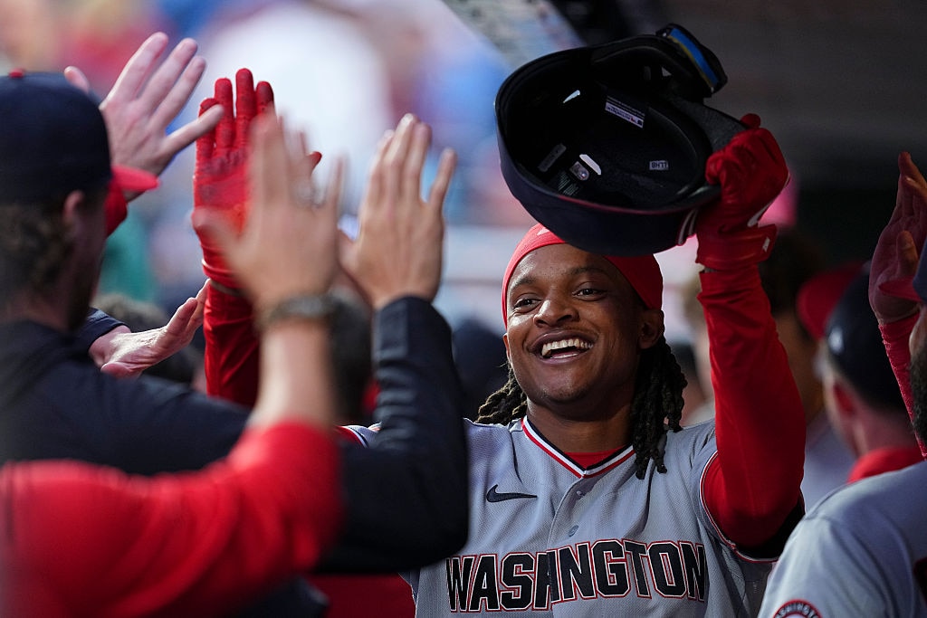 Washington Nationals shortstop CJ Abrams high fives teammates after scoring a run in the top of the first inning against the Philadelphia Phillies.