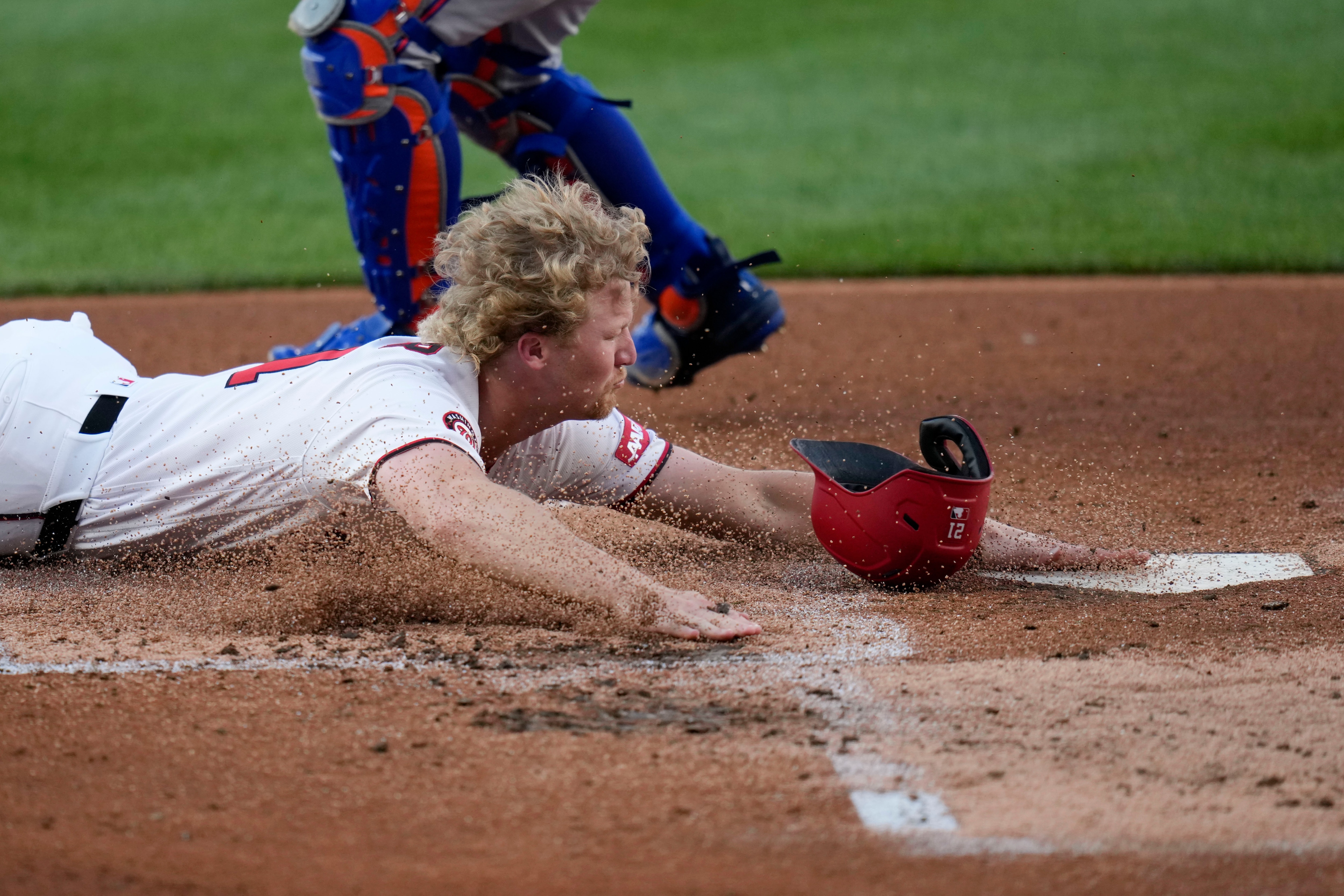 Washington Nationals center fielder Joey Wiemer slides into home plate as he scores against the New York Mets on a double hit by José Tena during the second inning.