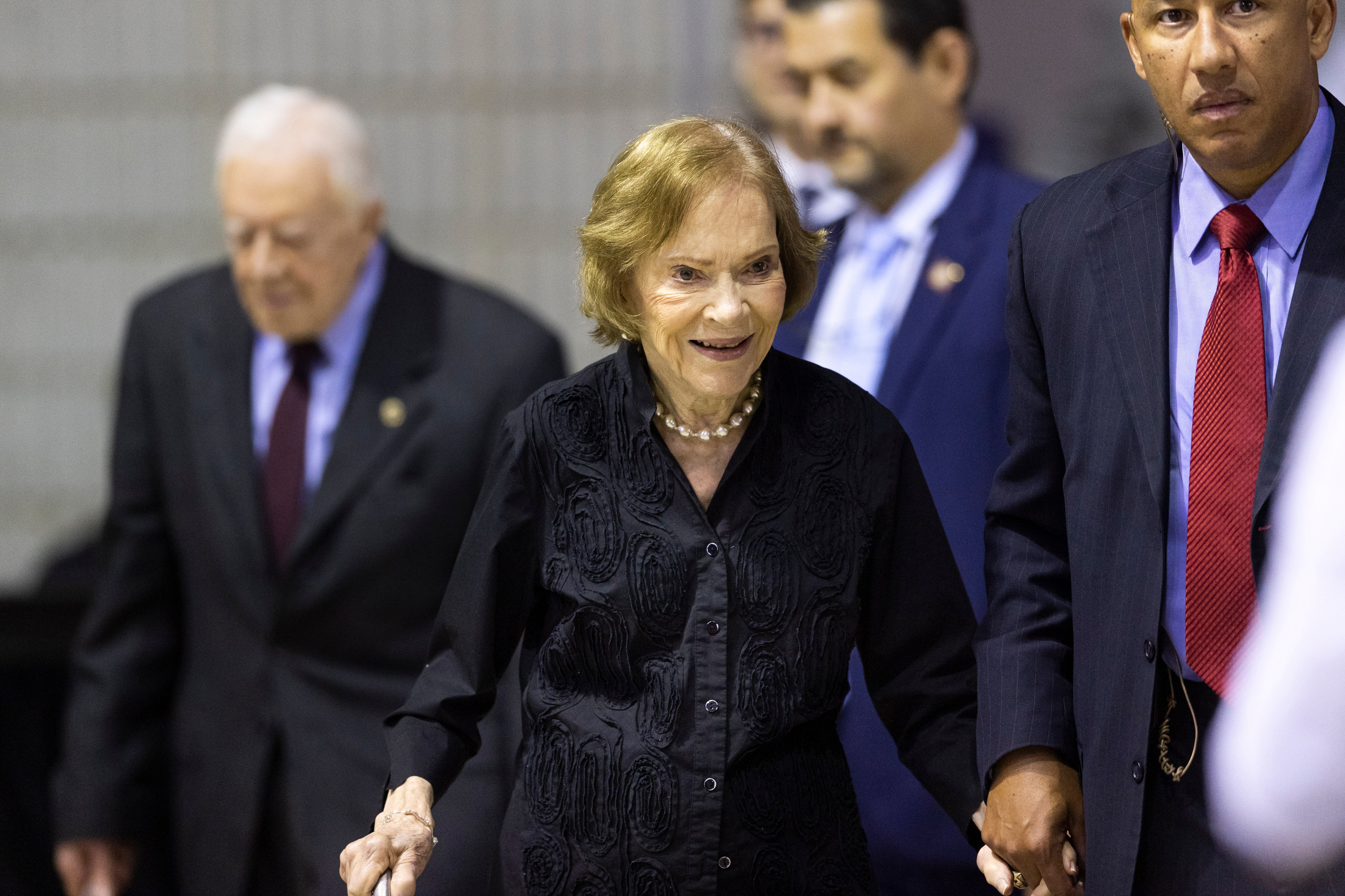 Former first lady Rosalynn Carter arrives with her husband, former President Jimmy Carter, left, for an annual Carter Town Hall held at Emory University in 2019.