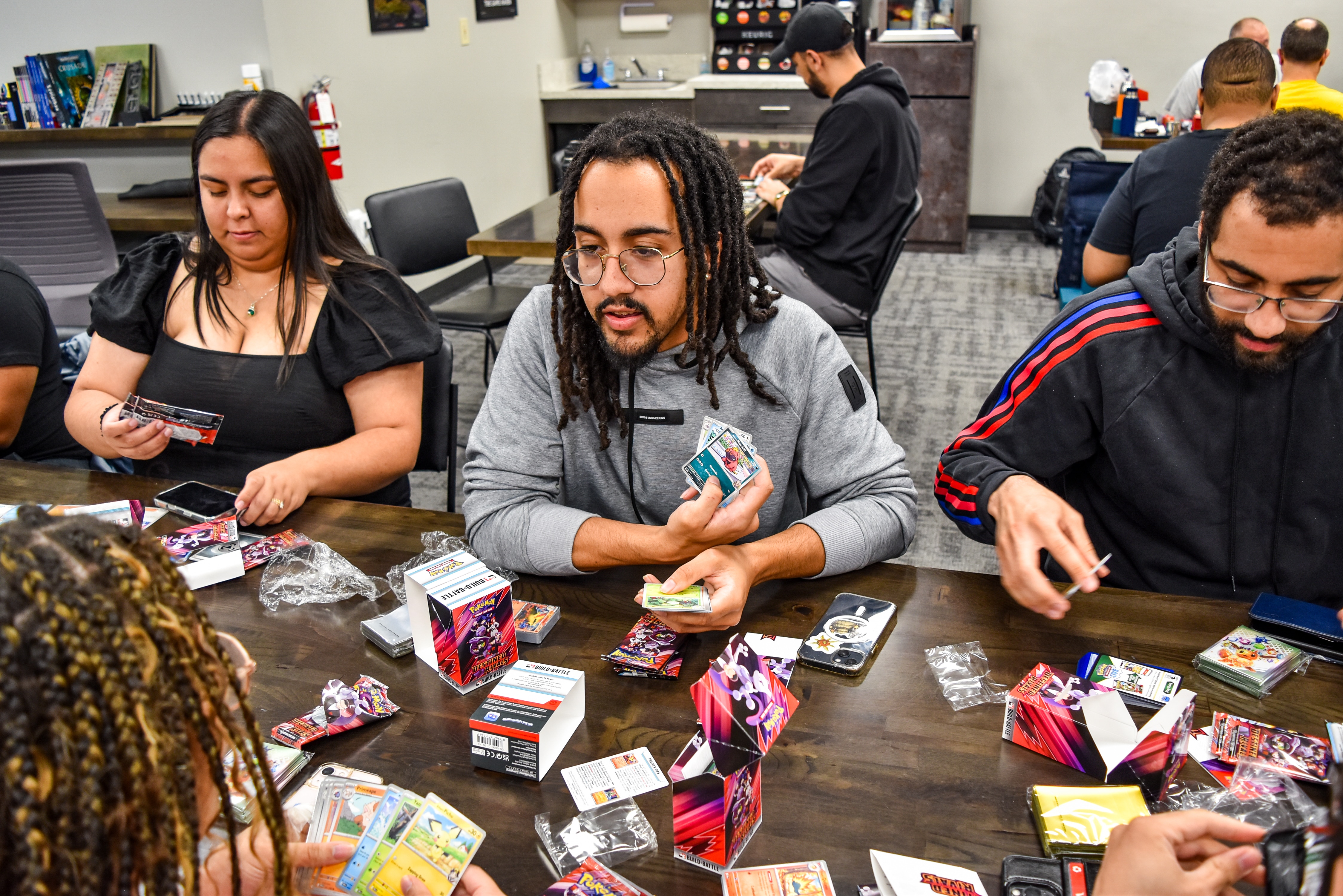 Jalen Manley and his twin sister, Bryanne Manley, discuss some of the cards they've opened from the new packs at Game Haven in Pikesville on Sunday, May 25, 2025.